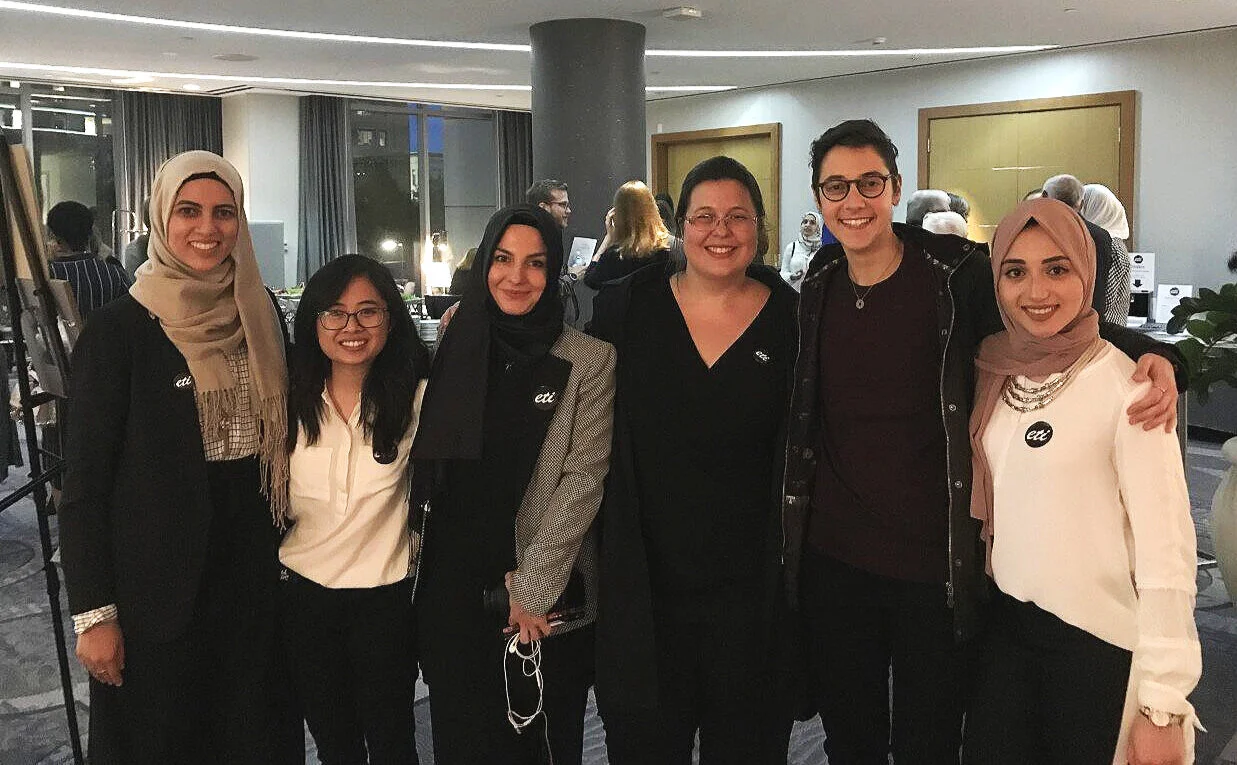 In this photo: Anna Barbosa, ETI Executive Director, and 5 ETI team members