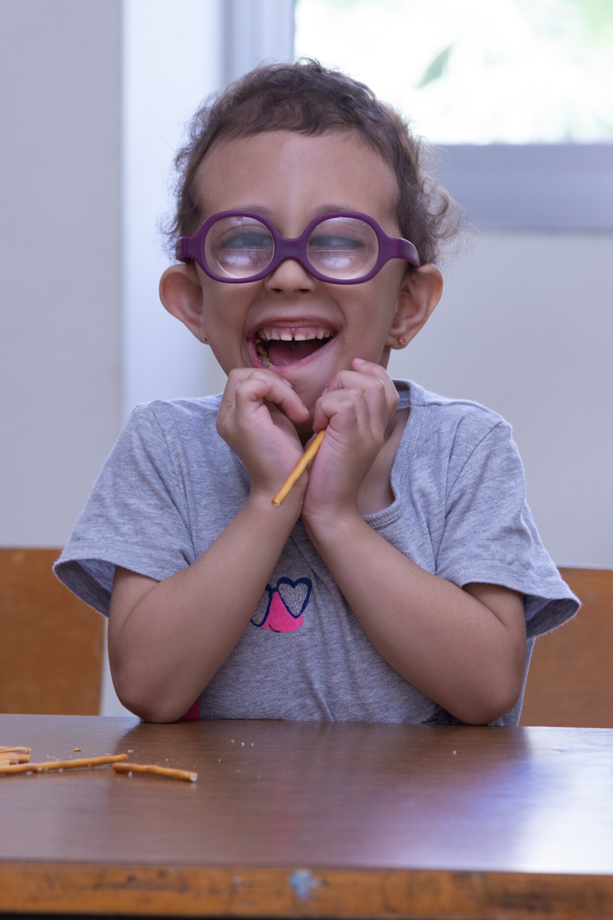 A young student smiles for the camera