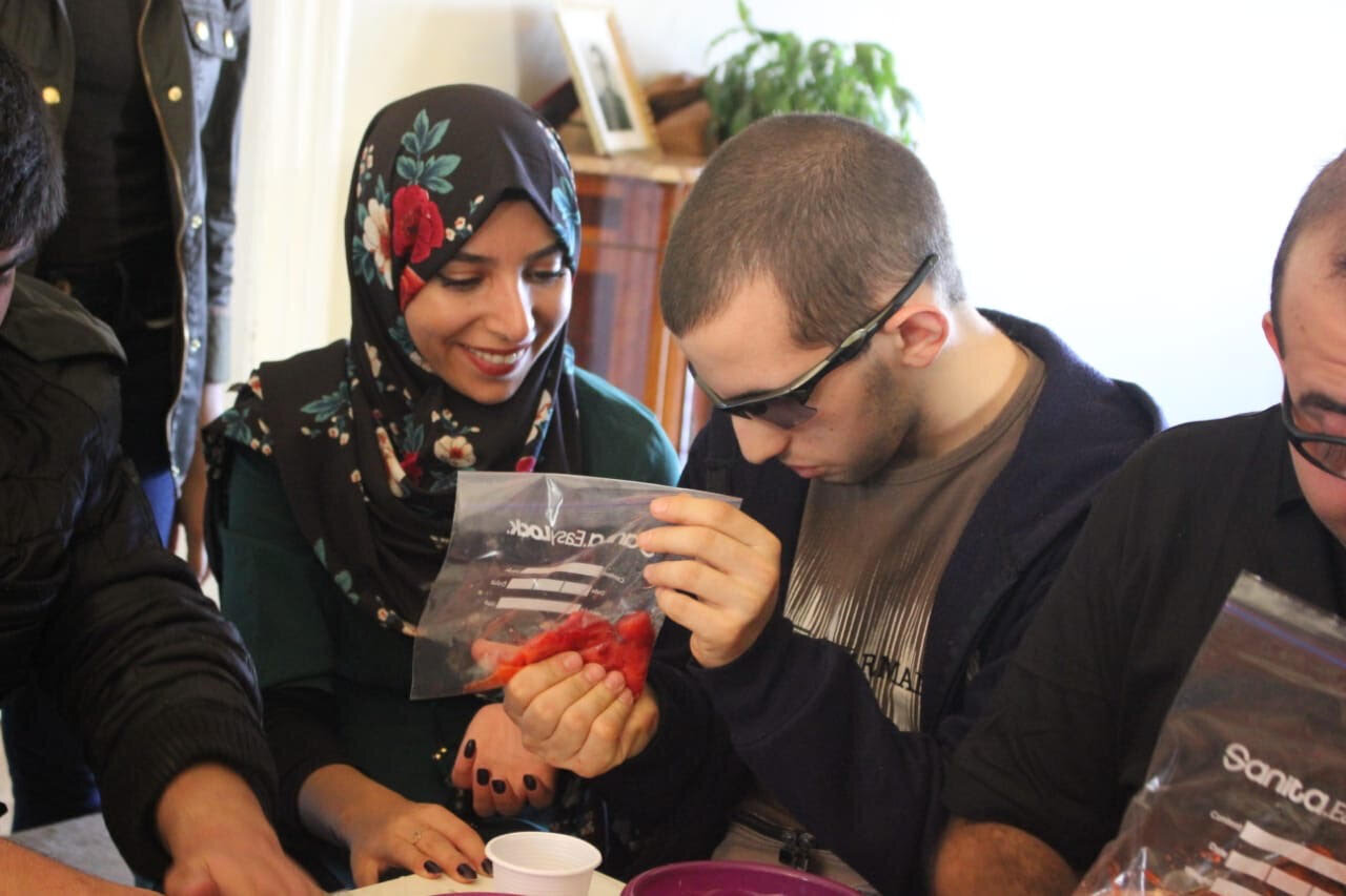 a child collaborating with a volunteer while doing experiments