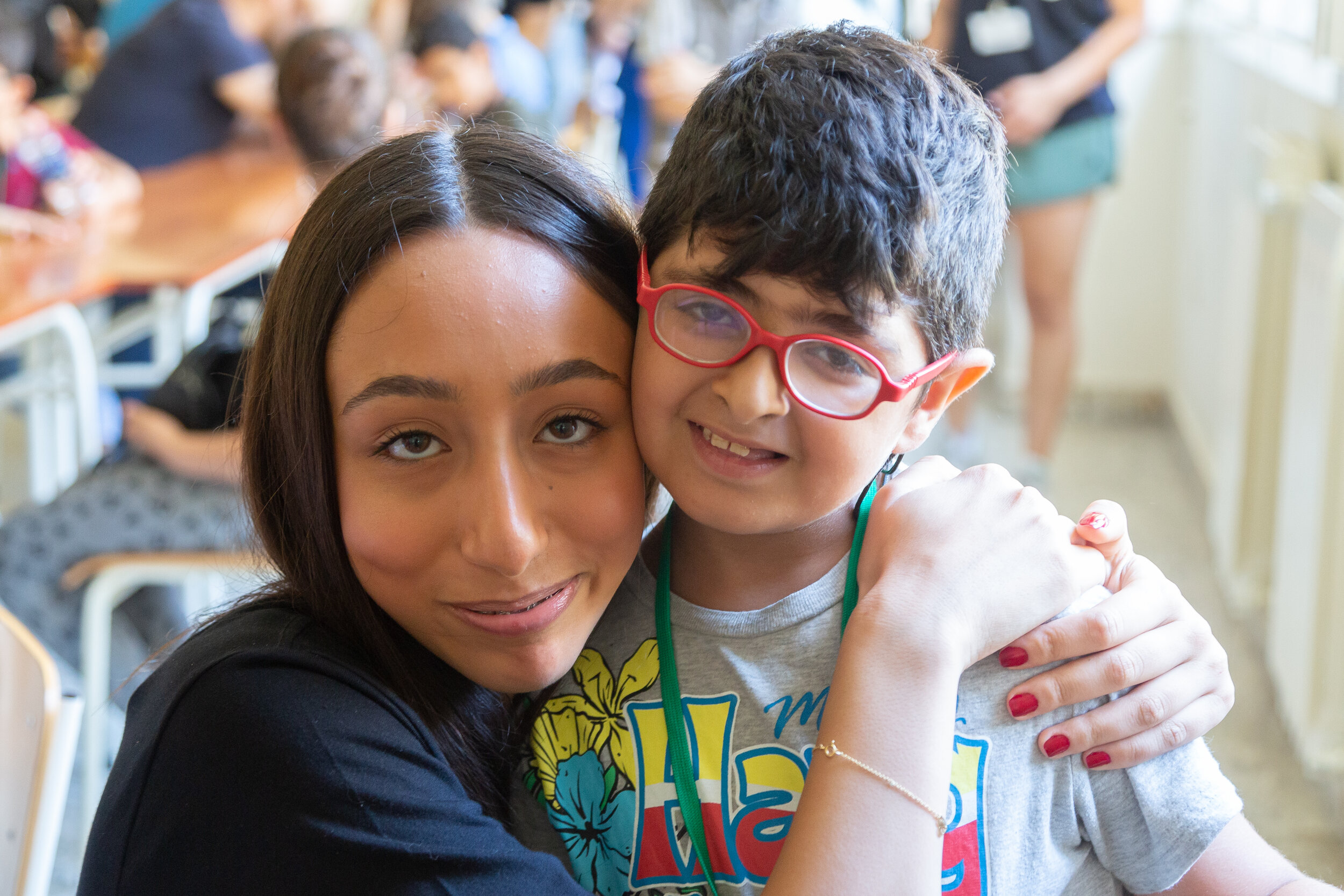 A volunteer poses with a young ETI participant