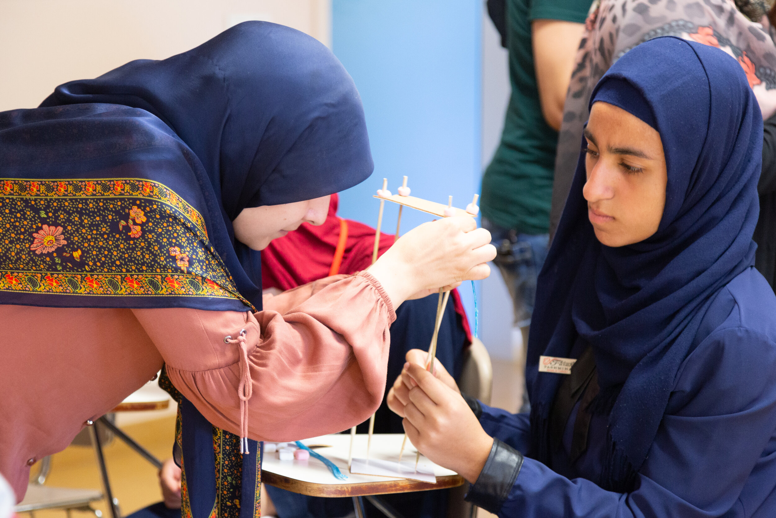 Volunteer and participant work together on an arts project