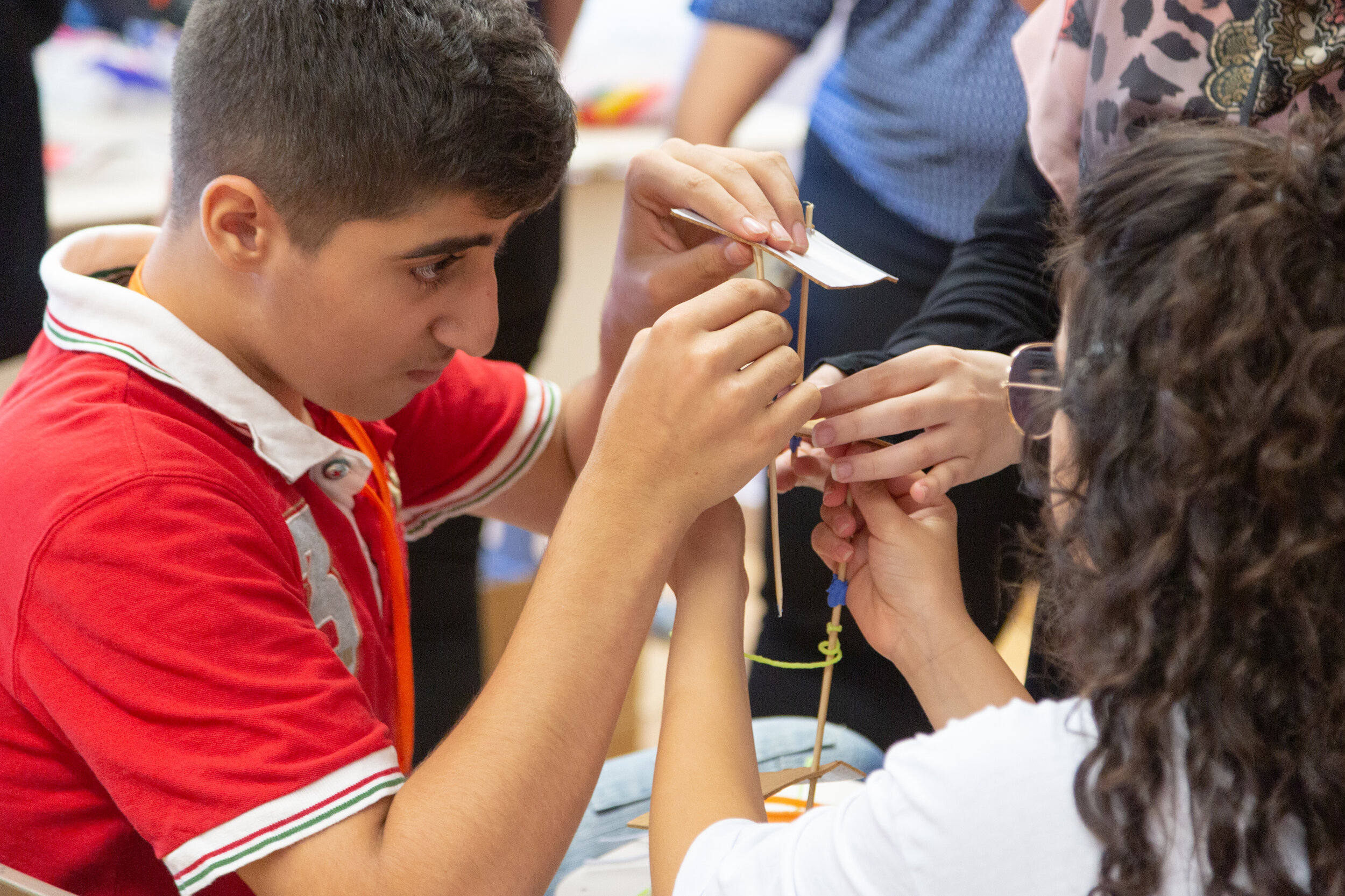 ETI program participants hold up their new art creation