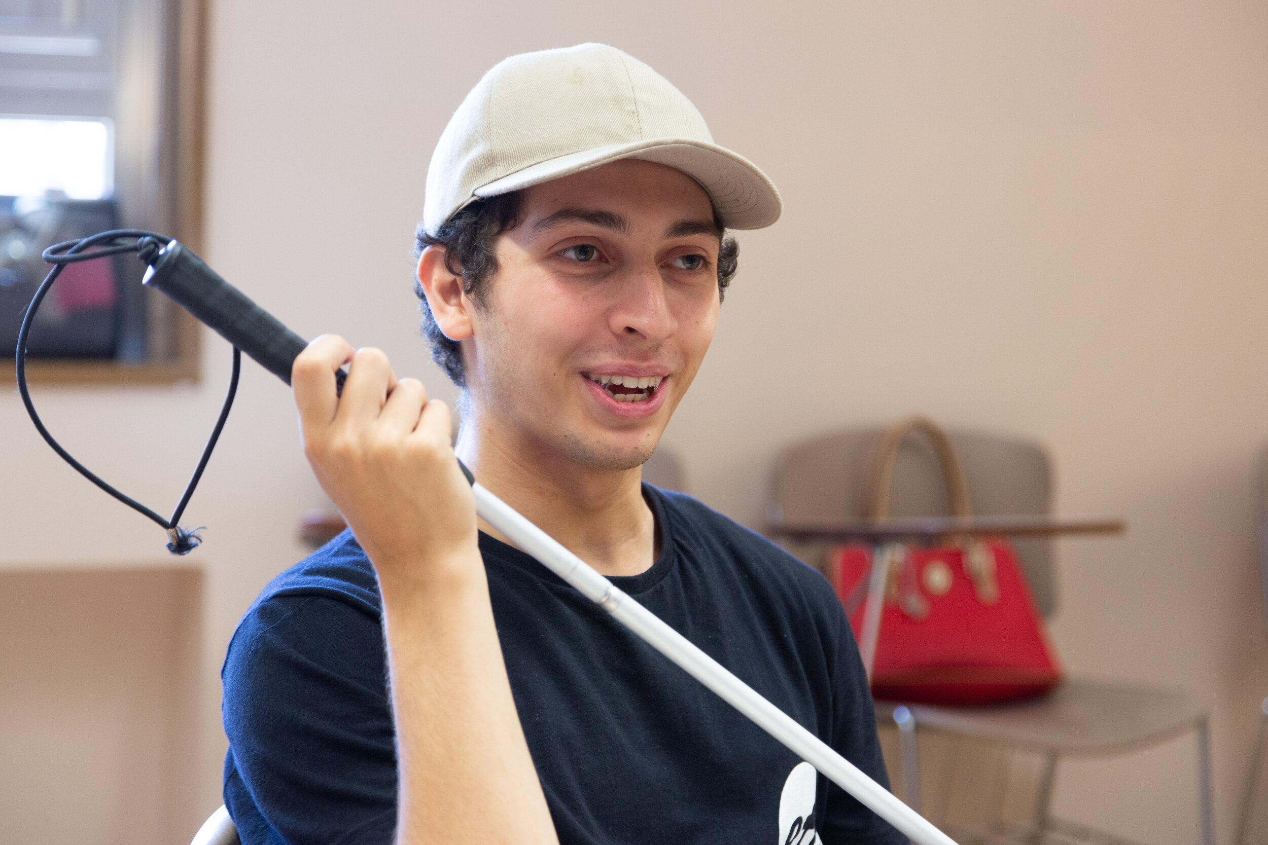 An ETI volunteer demonstrates a technique with his white cane
