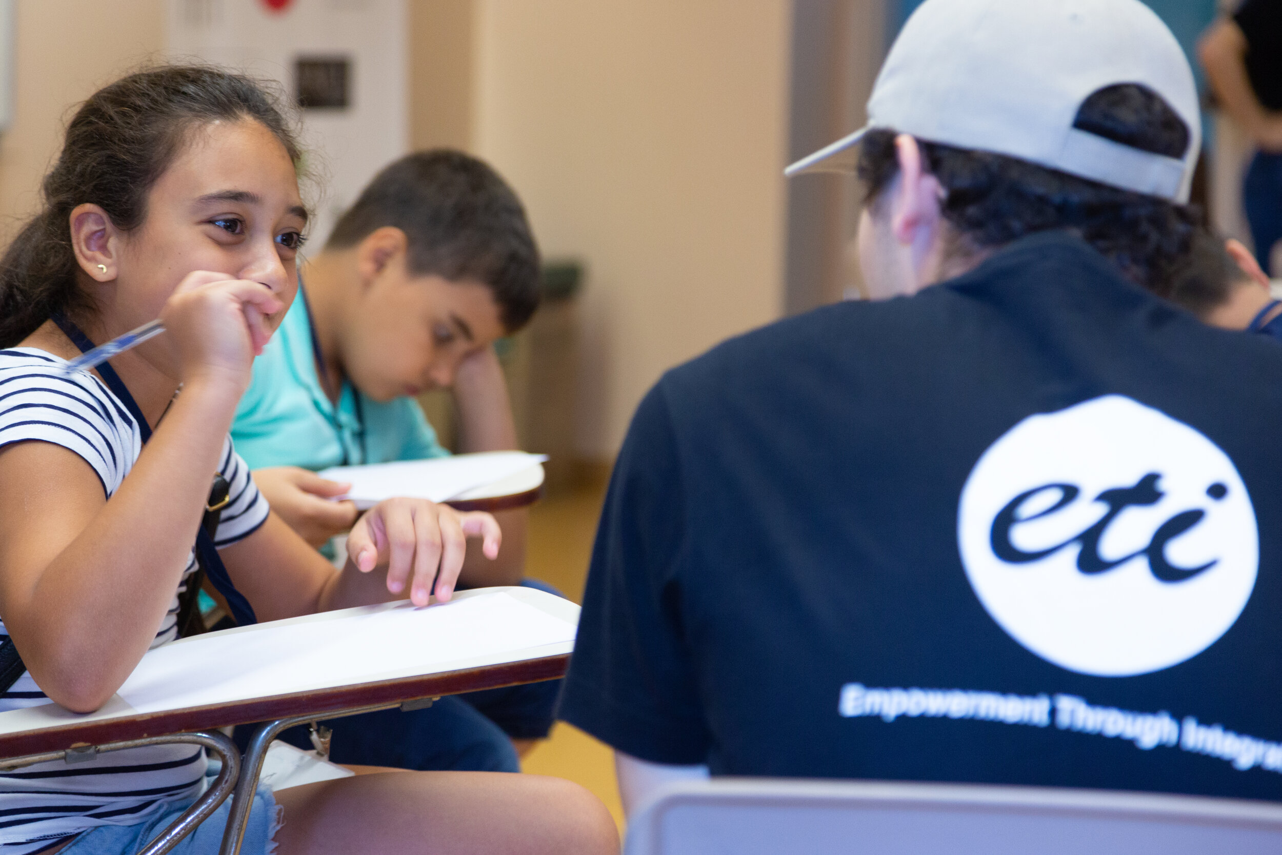 Students listen as an ETI instructor converses with them.