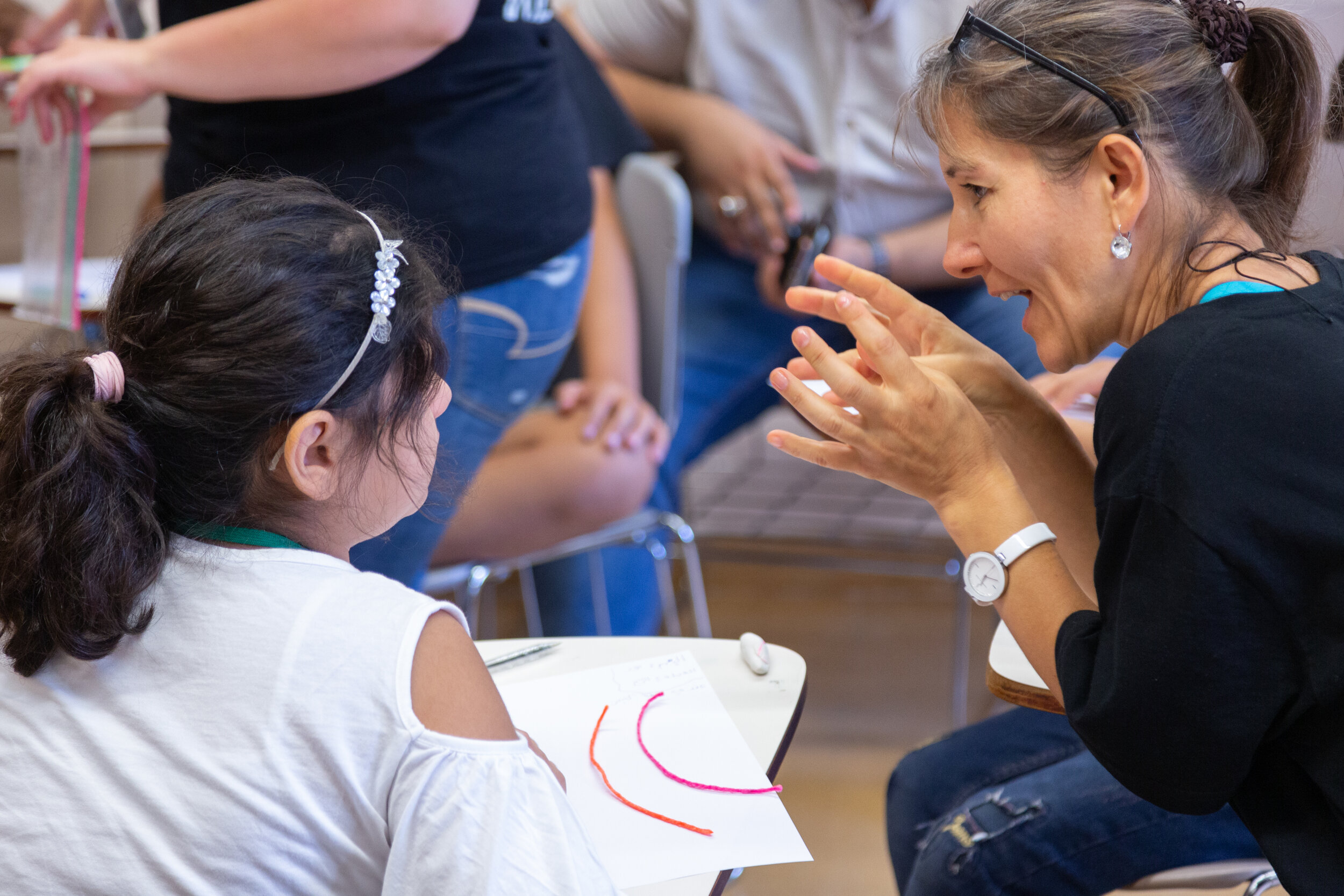 A student and instructor work together on an art project