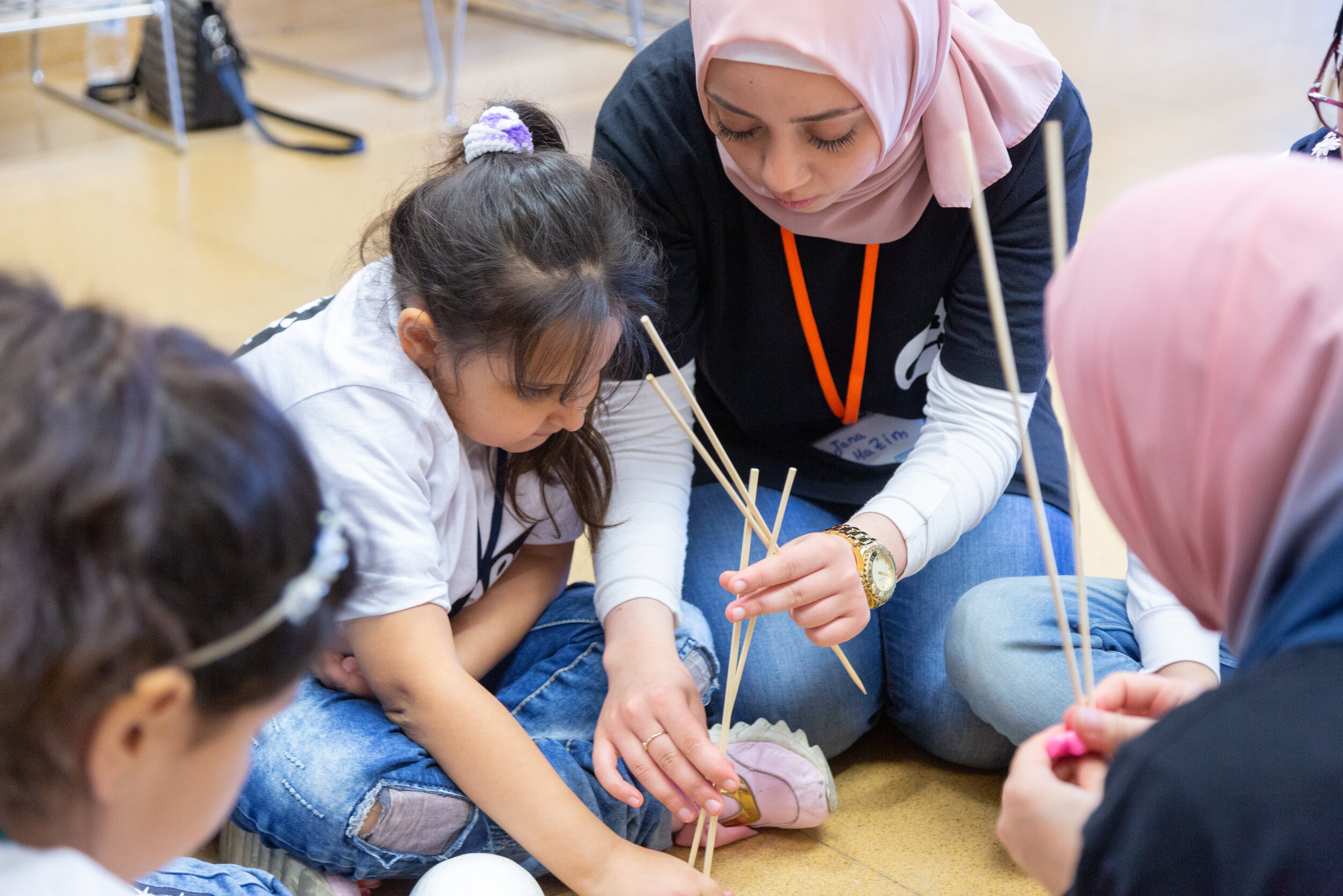 Instructors and students work closely together on an art project