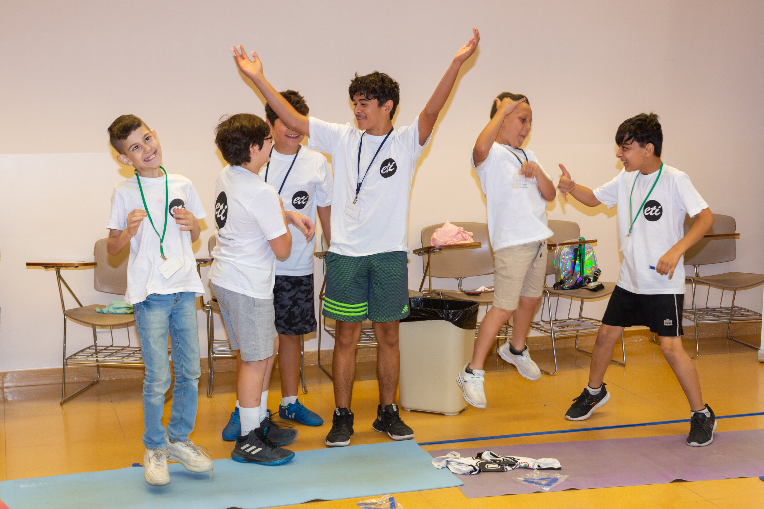 6 young participants celebrate during an athletic activity