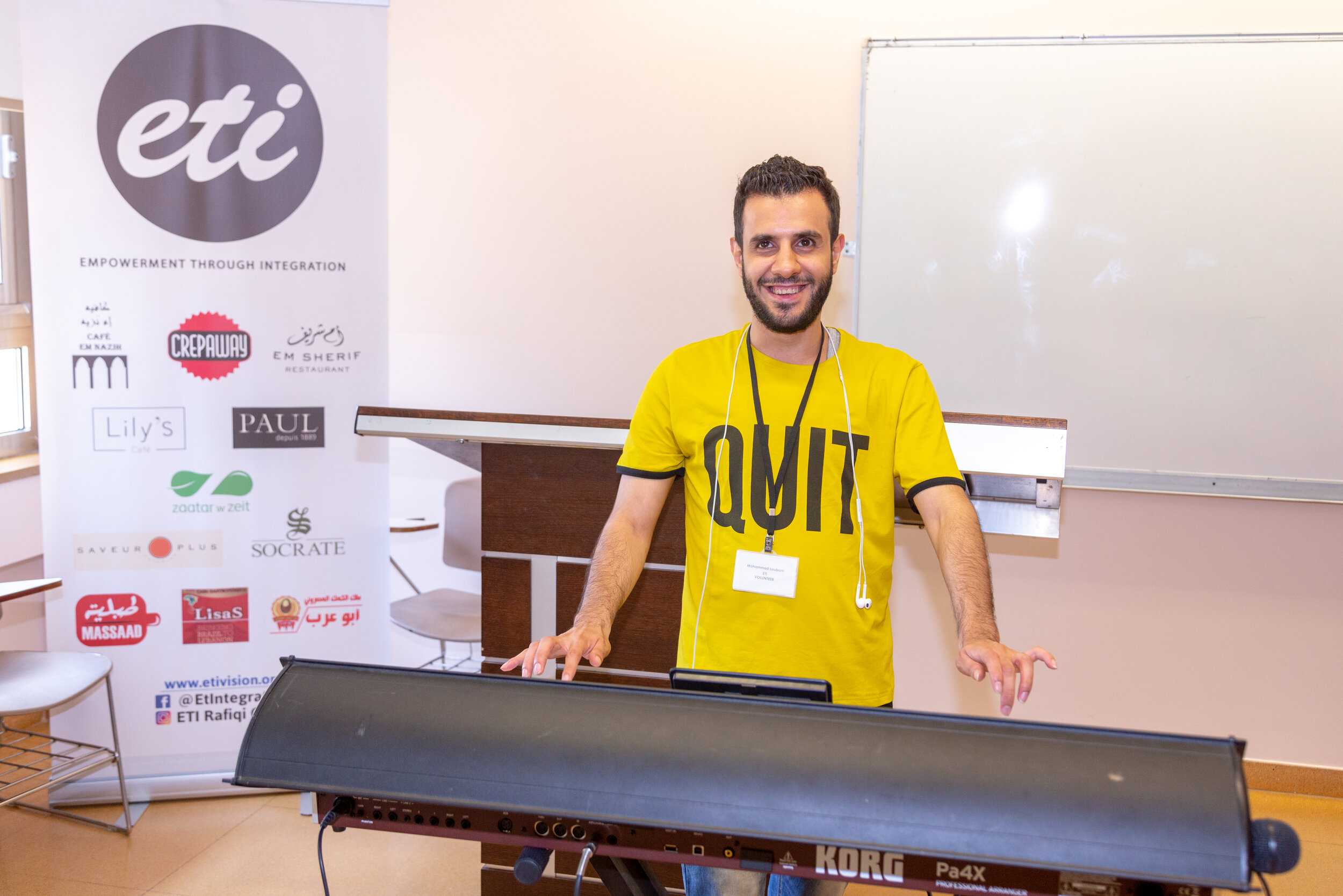 An ETI volunteer poses as his work desk