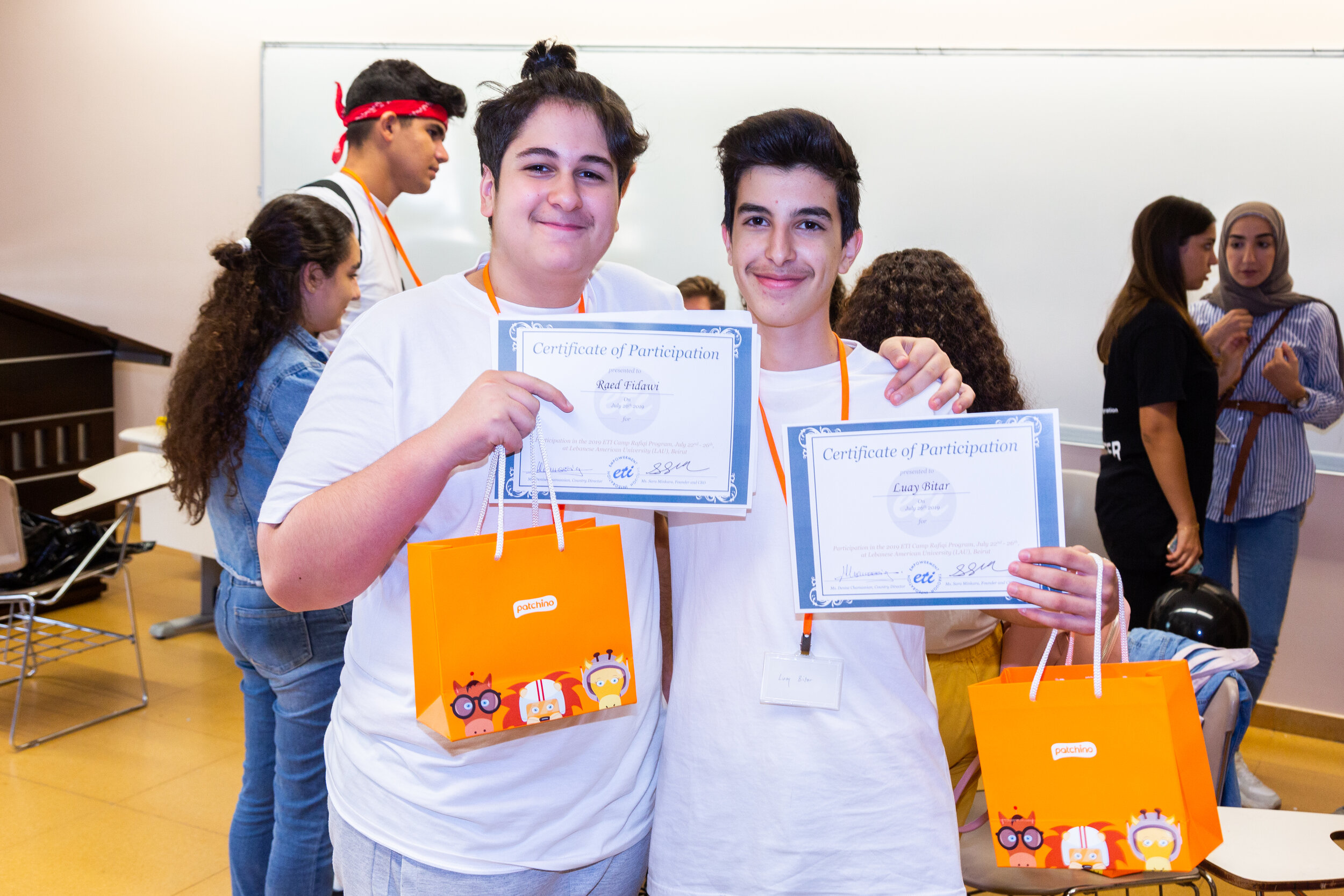 2 participants pose with their certificates of program completion