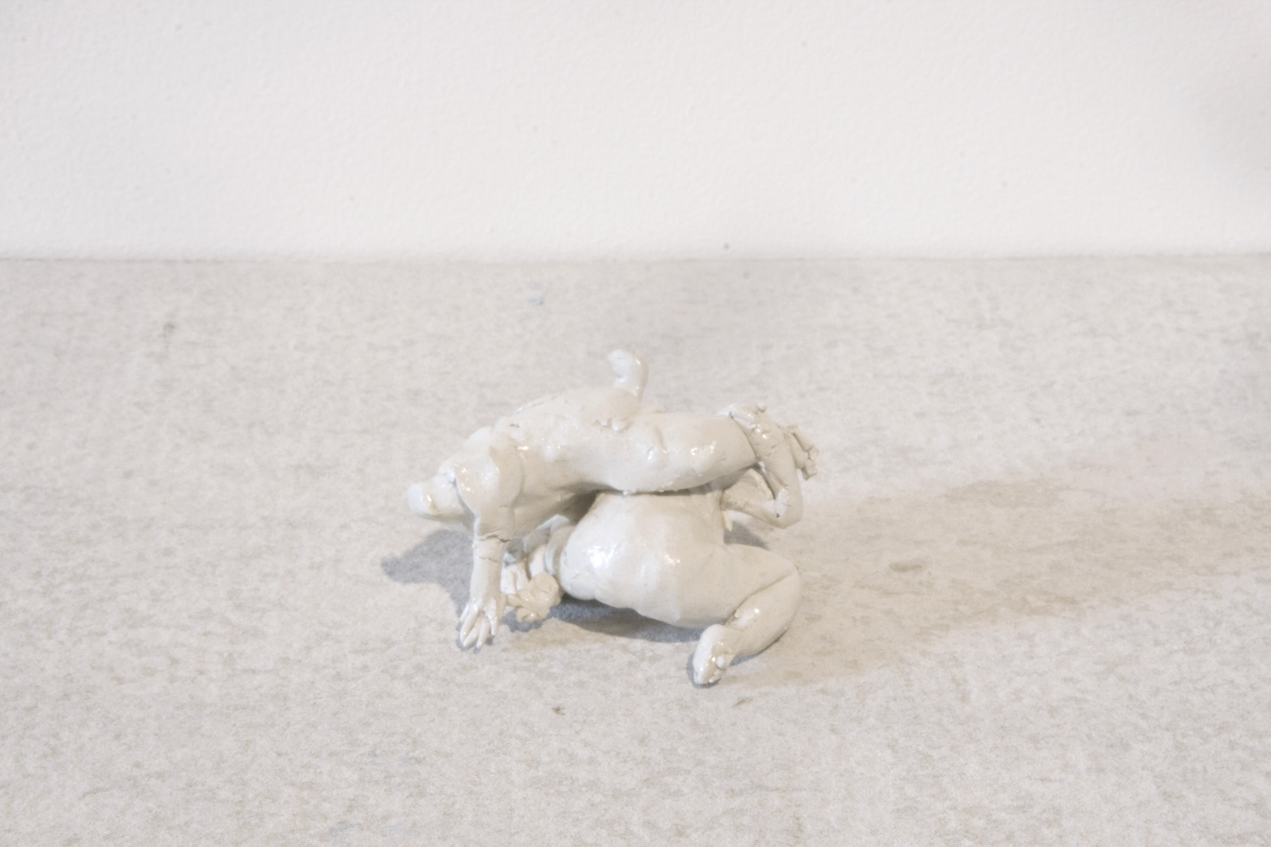 Wrestlers (figures) , clay, enamel and concrete shelf. Collaborative work with Llewellyn Millhouse .