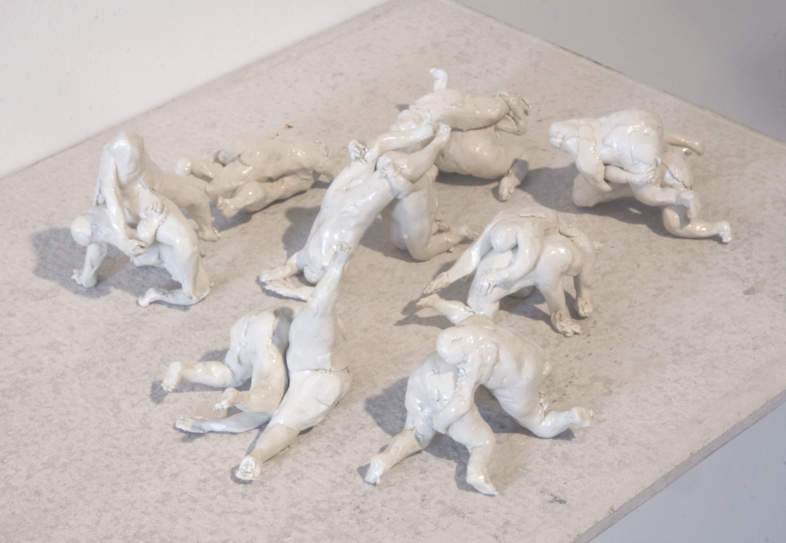 Wrestlers (figures) , clay, enamel and concrete shelf. Collaborative work with Llewellyn Millhouse .
