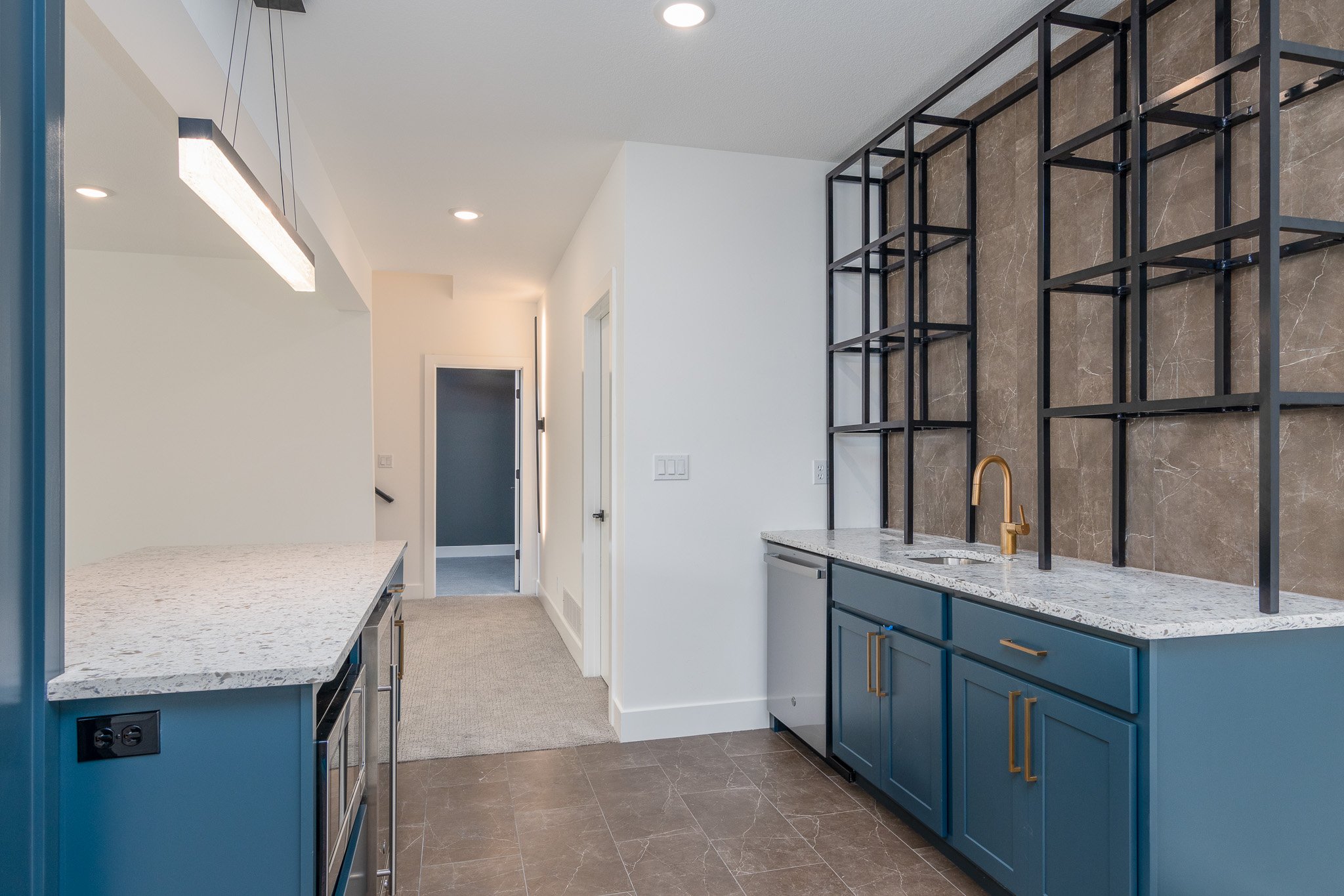 wet-bar-blue-cabinets-white-countertops-bar-shelves.jpg