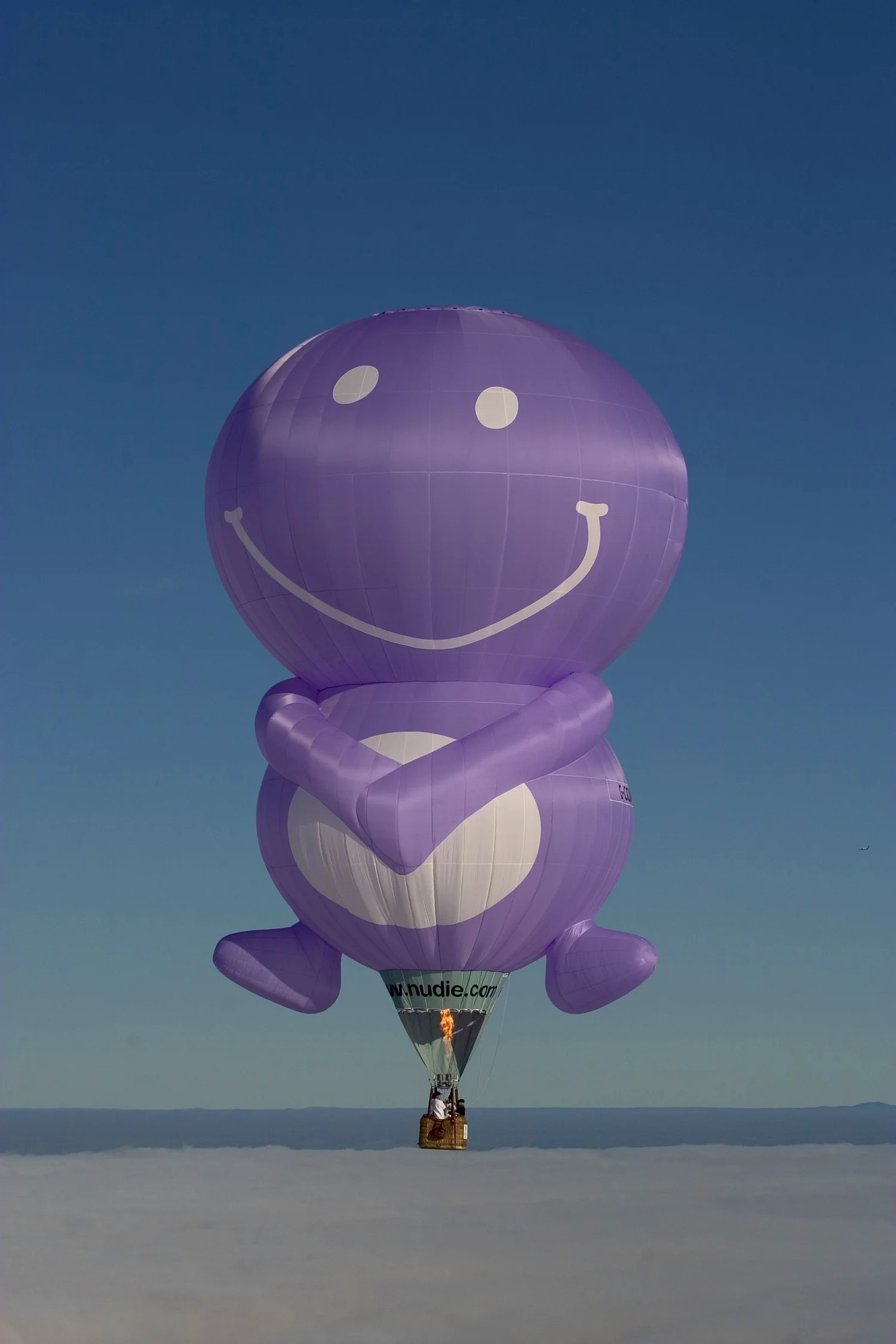 Nudie hot air balloon over clouds blue sky 040330.jpeg