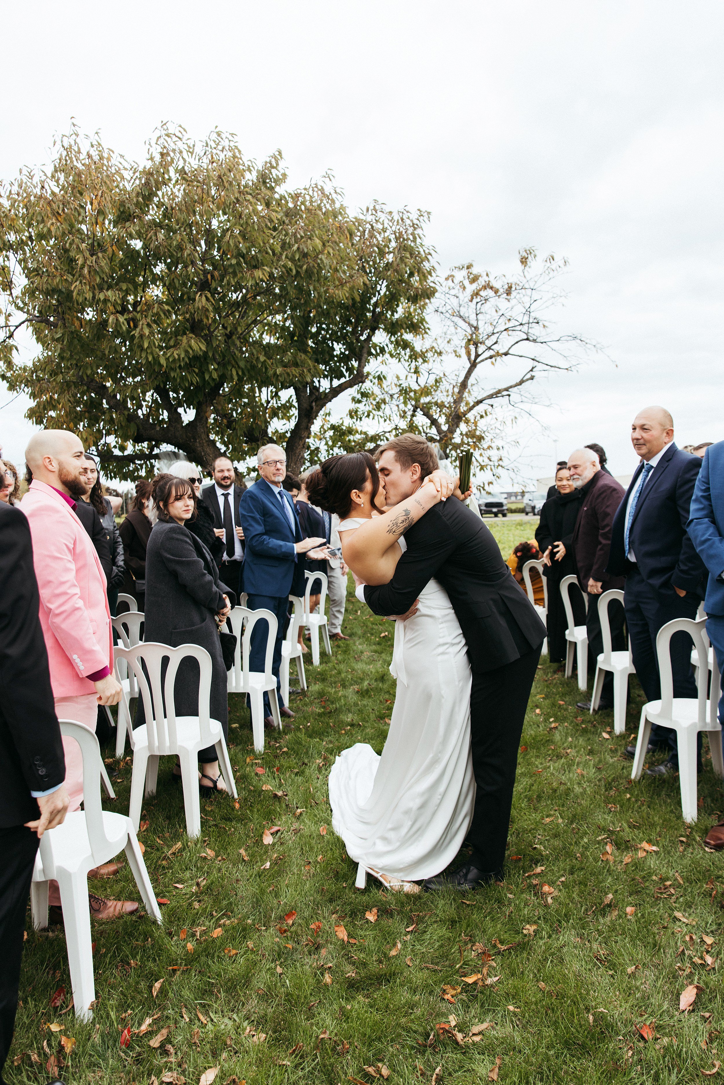 Couple Kiss in the Aisle at Wedding