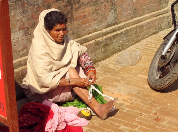 Kat_Woman knitting with toe.JPG