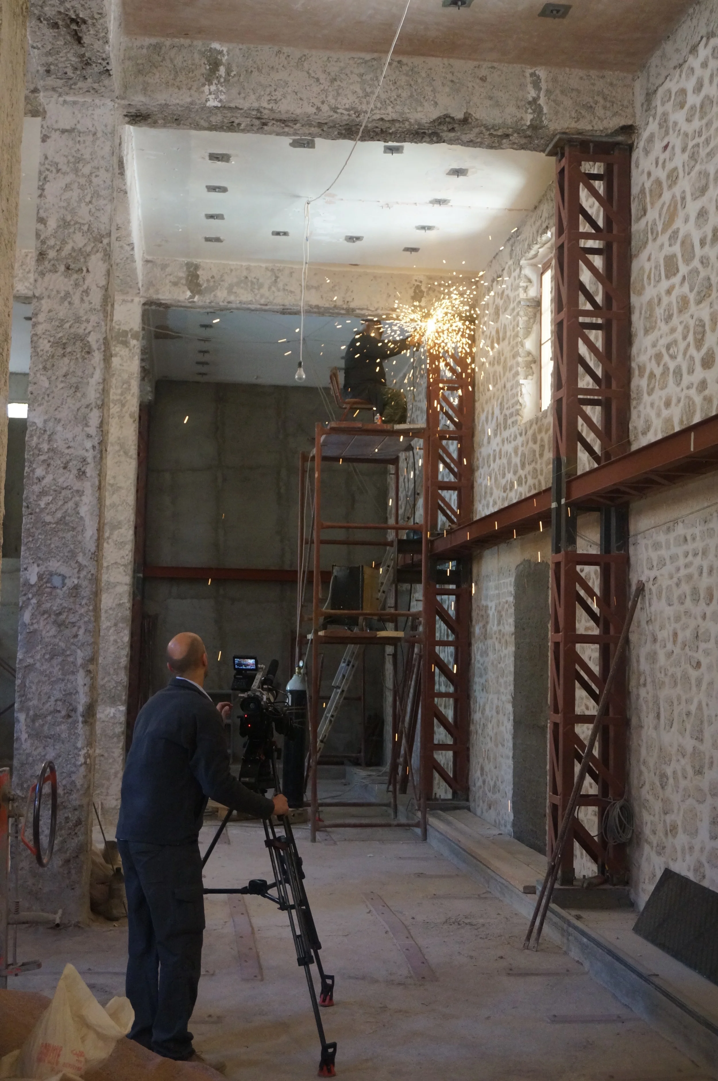 One of the Monks, moonlighting as a welder inside the library. Health and safety seems to be in God's hands here!