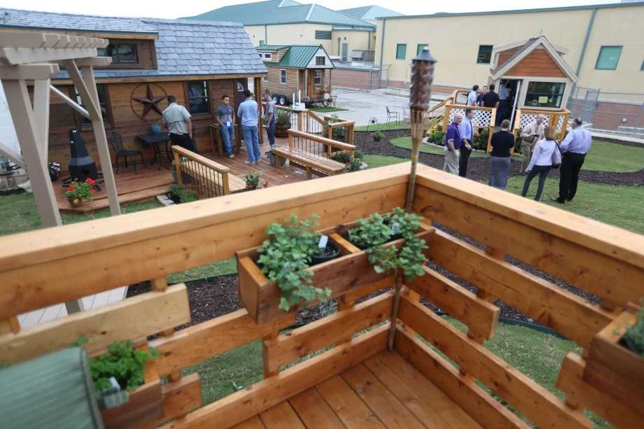 Construction Careers Academy Student Built Tiny Houses; Tiny House Expedition Parked in the Background