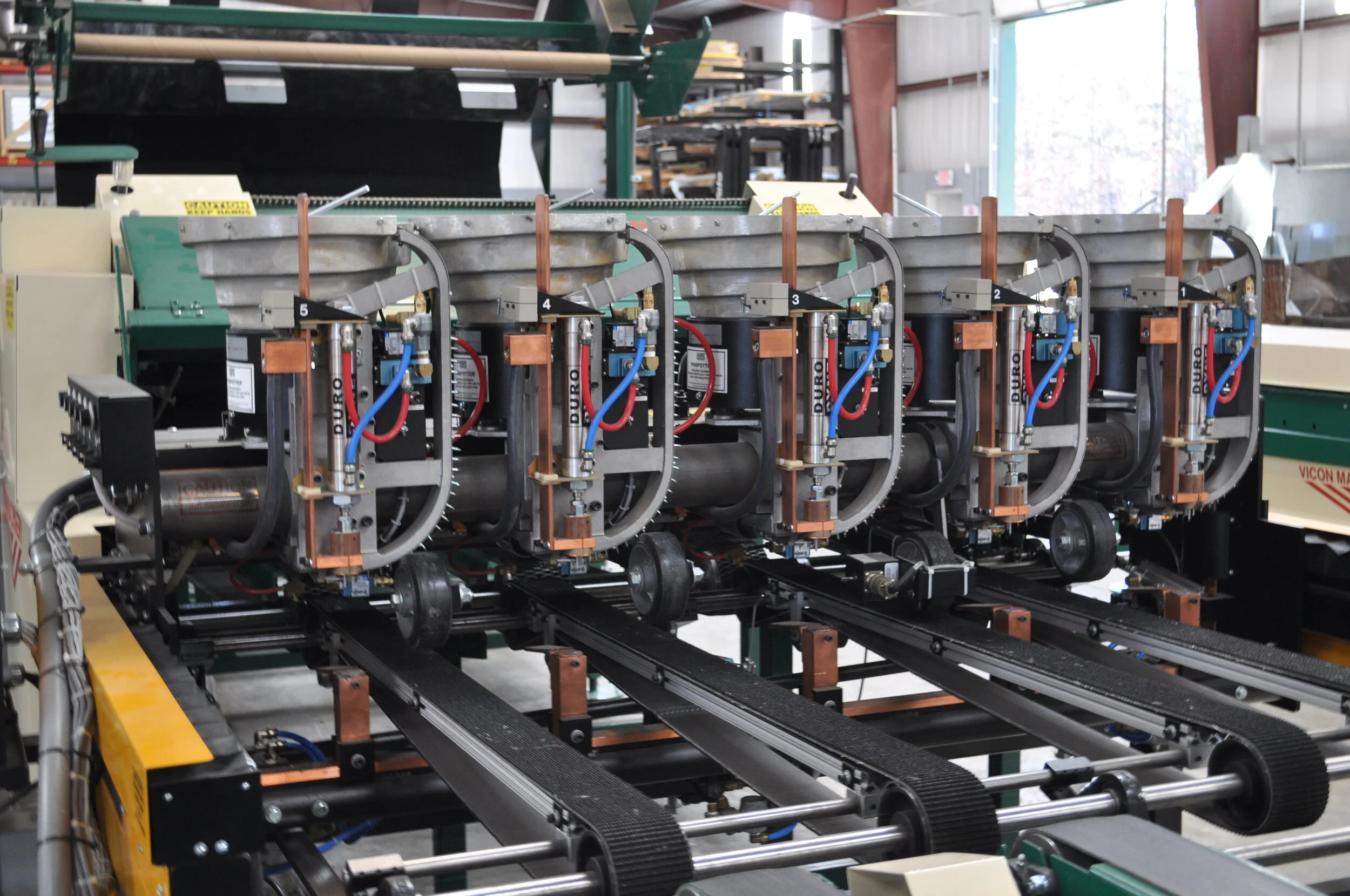 Five pin spotters work in perfect harmony to secure pre-glued liner to the interior of the duct.