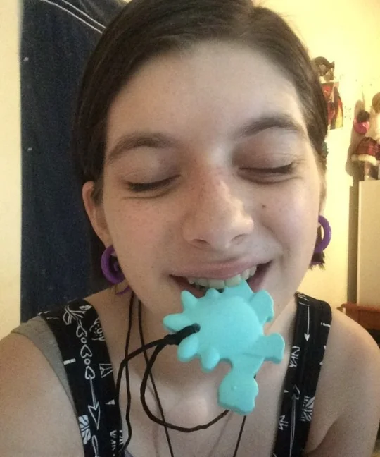 Atlas, with a chewable stegosaurus pendant