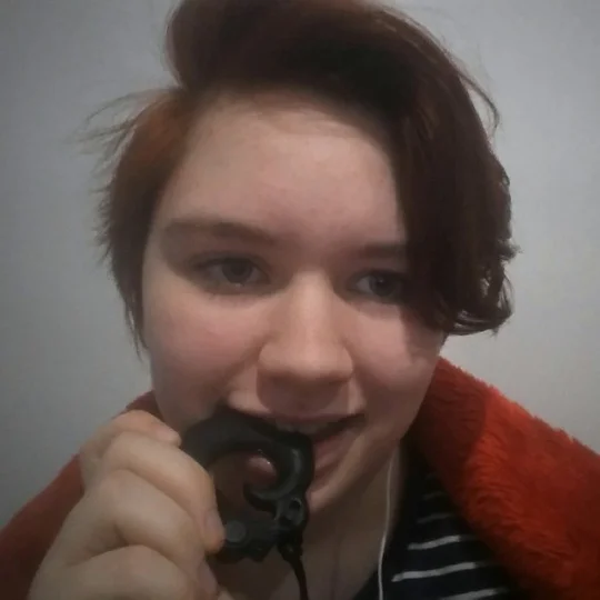 Isobel, with a chewable phoenix pendant