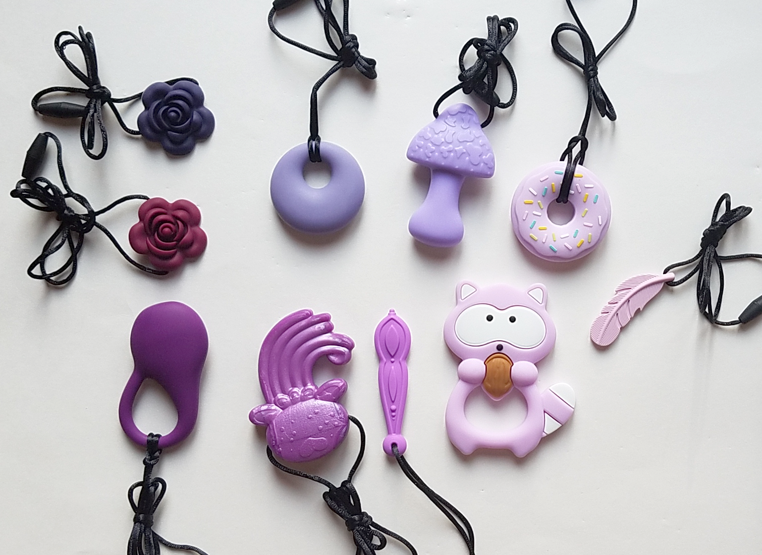 Clockwise from top left: twilight purple blossom, amethyst annular, thistle mushroom, purple donut, purple feather, purple raccoon, lilac dulcimer, purple jellyfish, plum Kleintastic, garnet blossom.