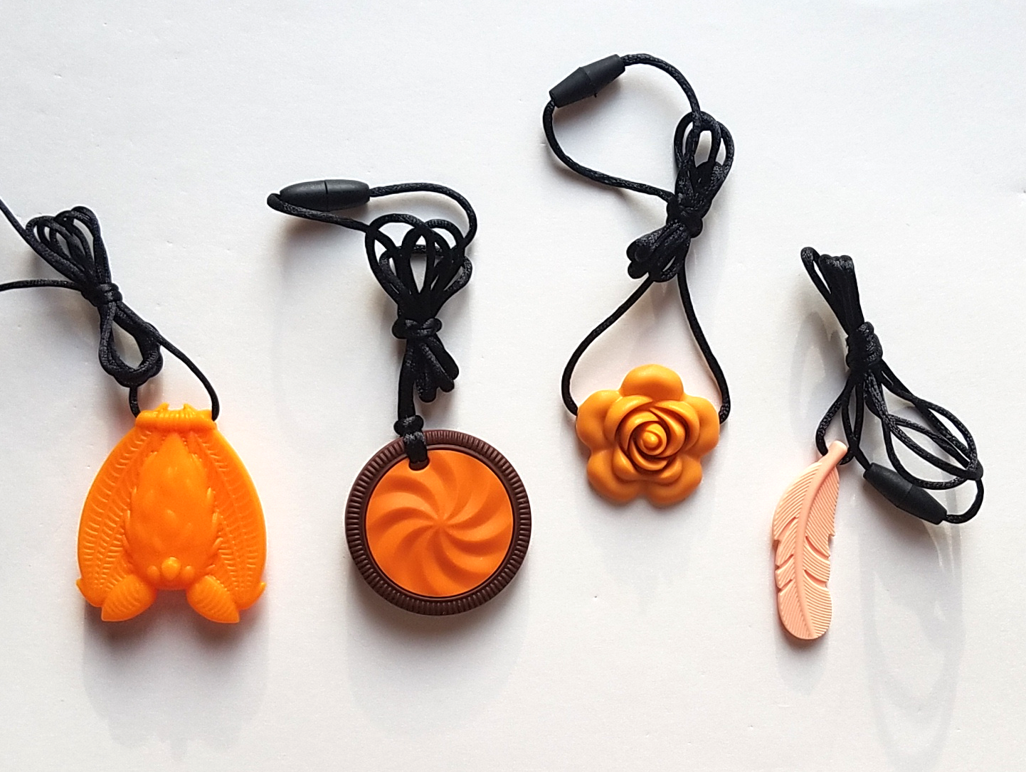 From top left: Orange bat, orange cookie, mango blossom, peach feather.