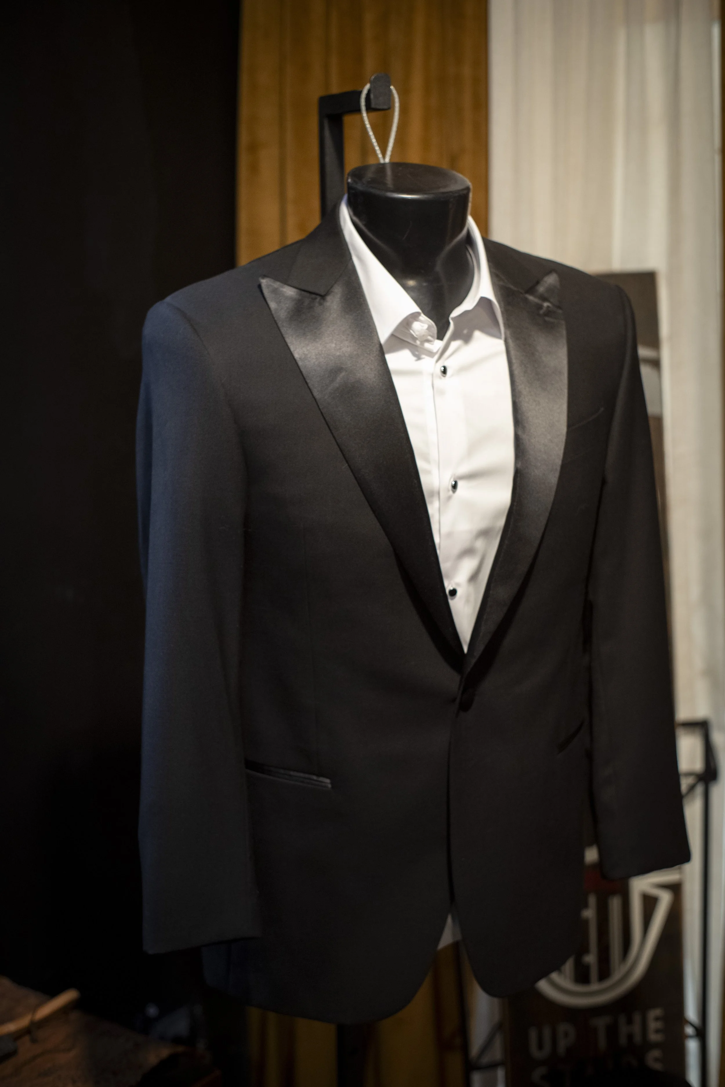 Tuxedo suit rental near me in Tampa at Bib 'N Tux by 1942 Clothiers. Black peak lapel tuxedo.