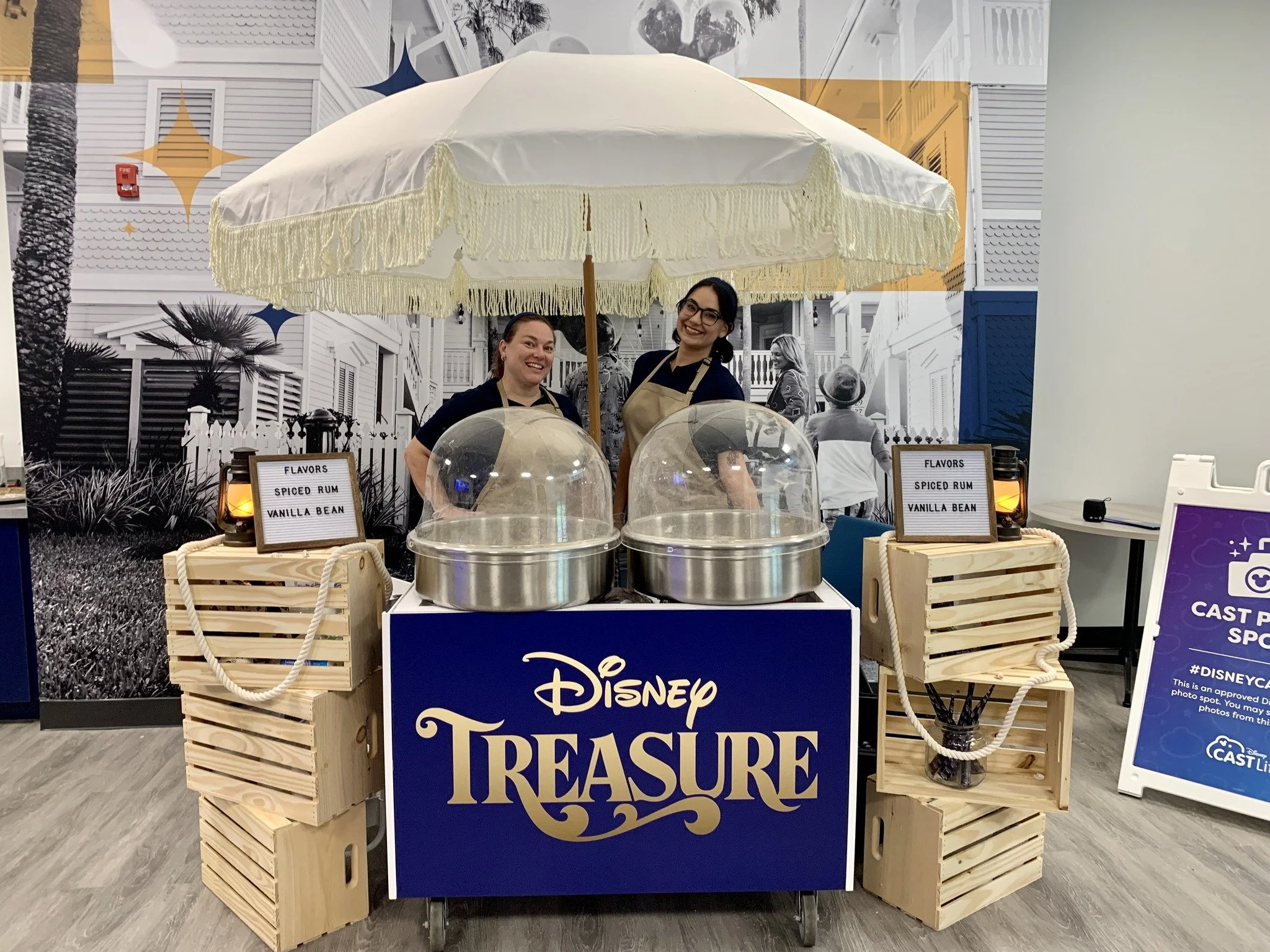 A cotton candy cart with two machines and attendants