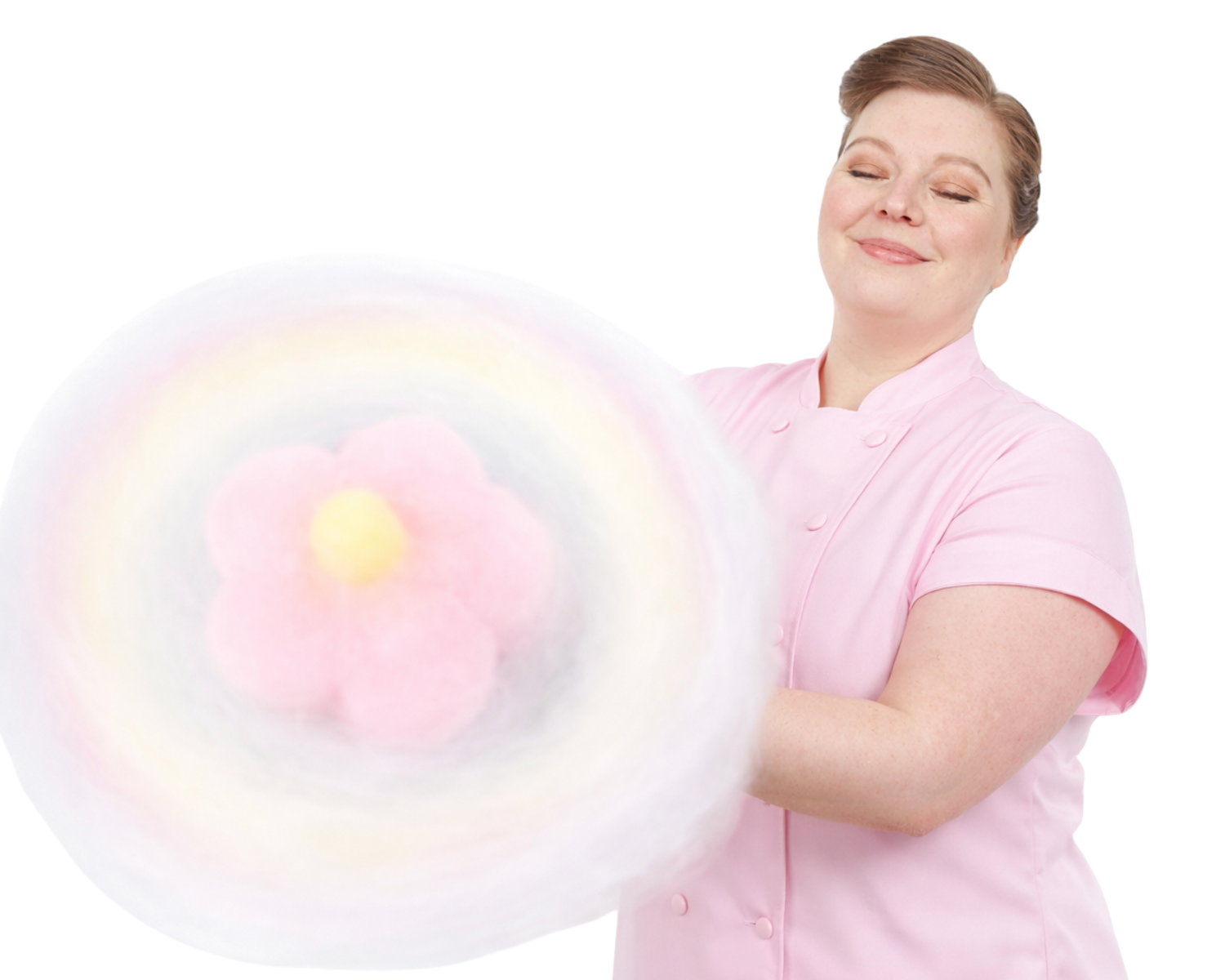 A cotton candy artist in a pink chefs coat holds a cotton candy flower