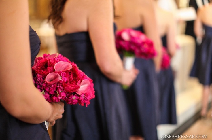 Bridesmaids carried bouquets of mixed flowers in hot pink tones including callas, stock flower and peonies.