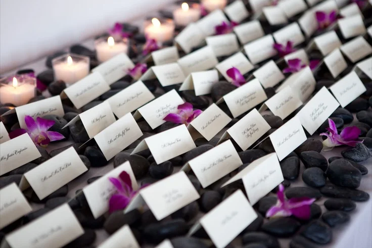 For the card table we lined the table with black river rock (again pulling in that natural element) with single dendrobian blooms and square candles to add a decorative element to the table, giving it a simple stylish look