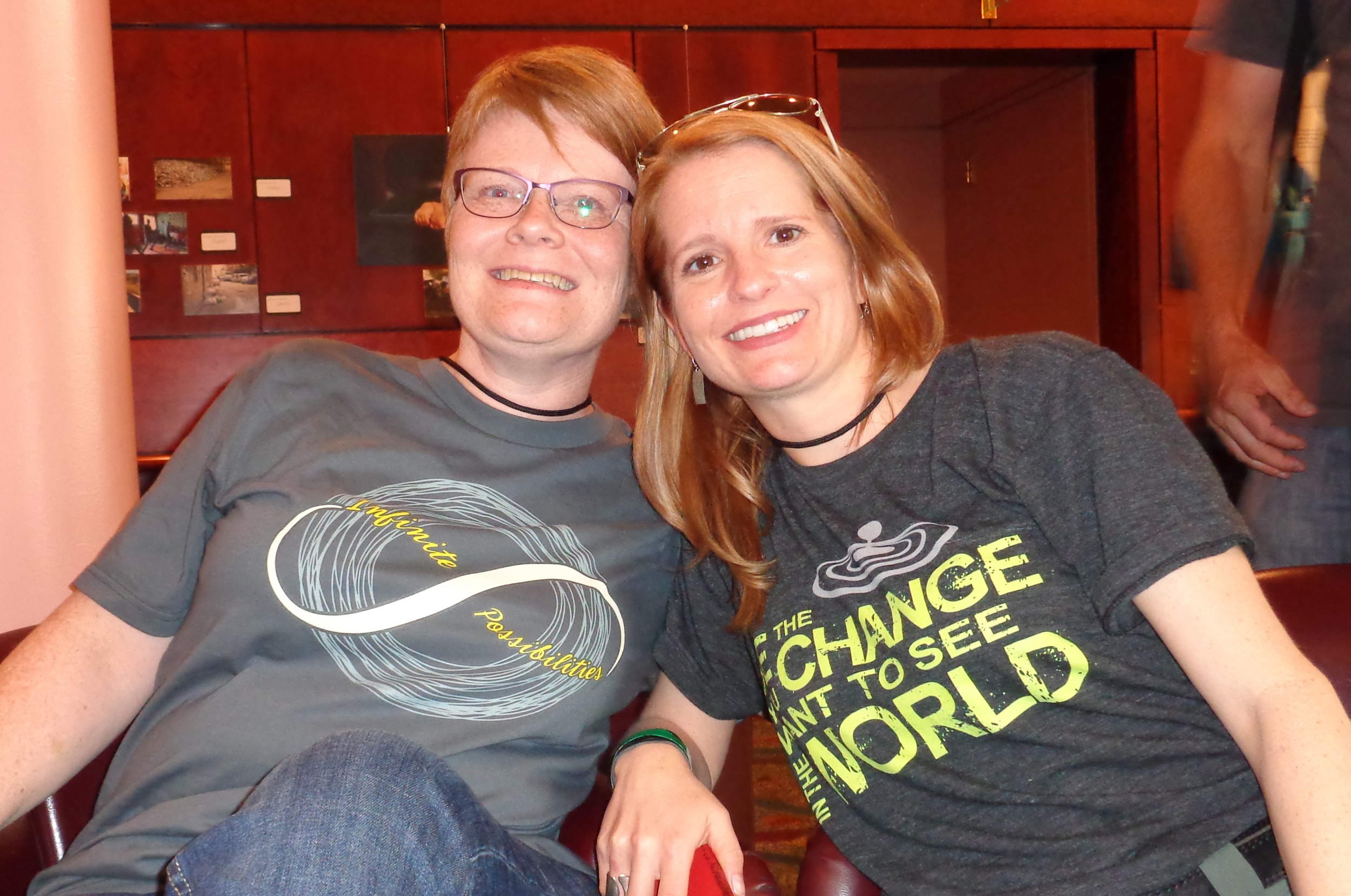 Two of my amazing friends, Melanie and Dorene, from the Rock Your Purpose Live (RYPL) community each sporting T-shirts that I designed and created for both the RYPL community (“Infinite Possibilities” T-shirt) and my community as well (“Be The Change You Want To See In The World” T-shirt).
