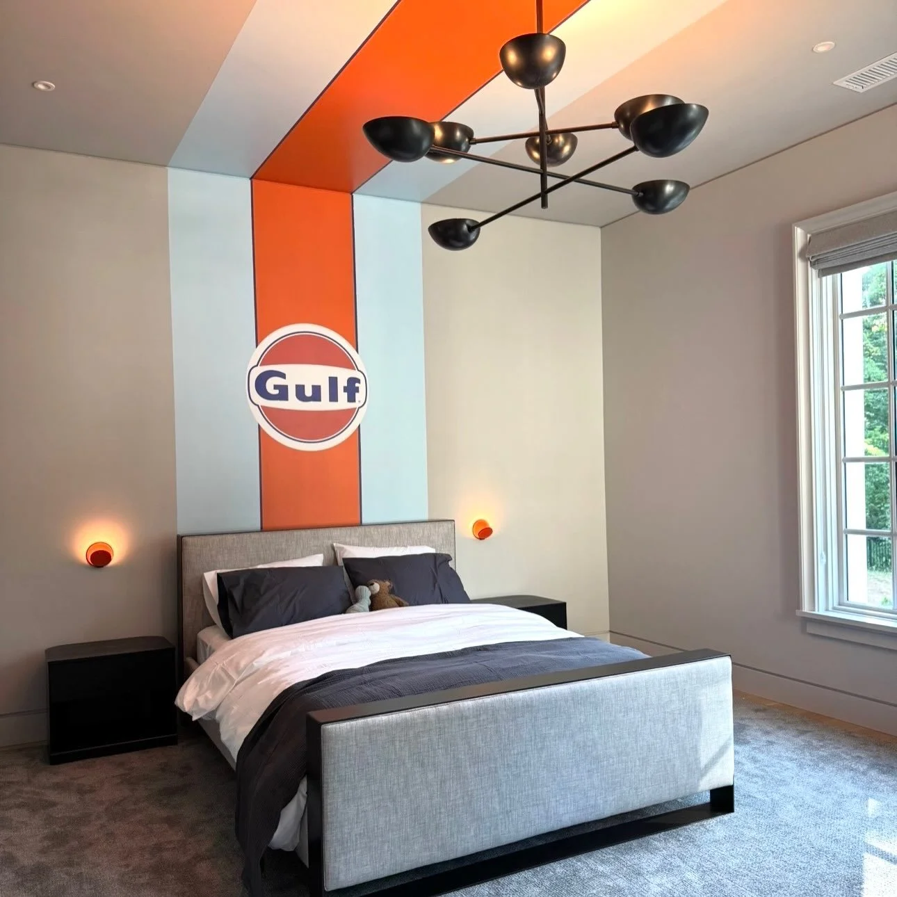Client and son wanted not a cars theme, but the real deal: Gulf Racing&rsquo;s livery. Every inch was mapped out before it hit the wall. Swipe to see the palette (@benjaminmoore Racing Orange + Light Blue) and the elevation we drew for the team. The 