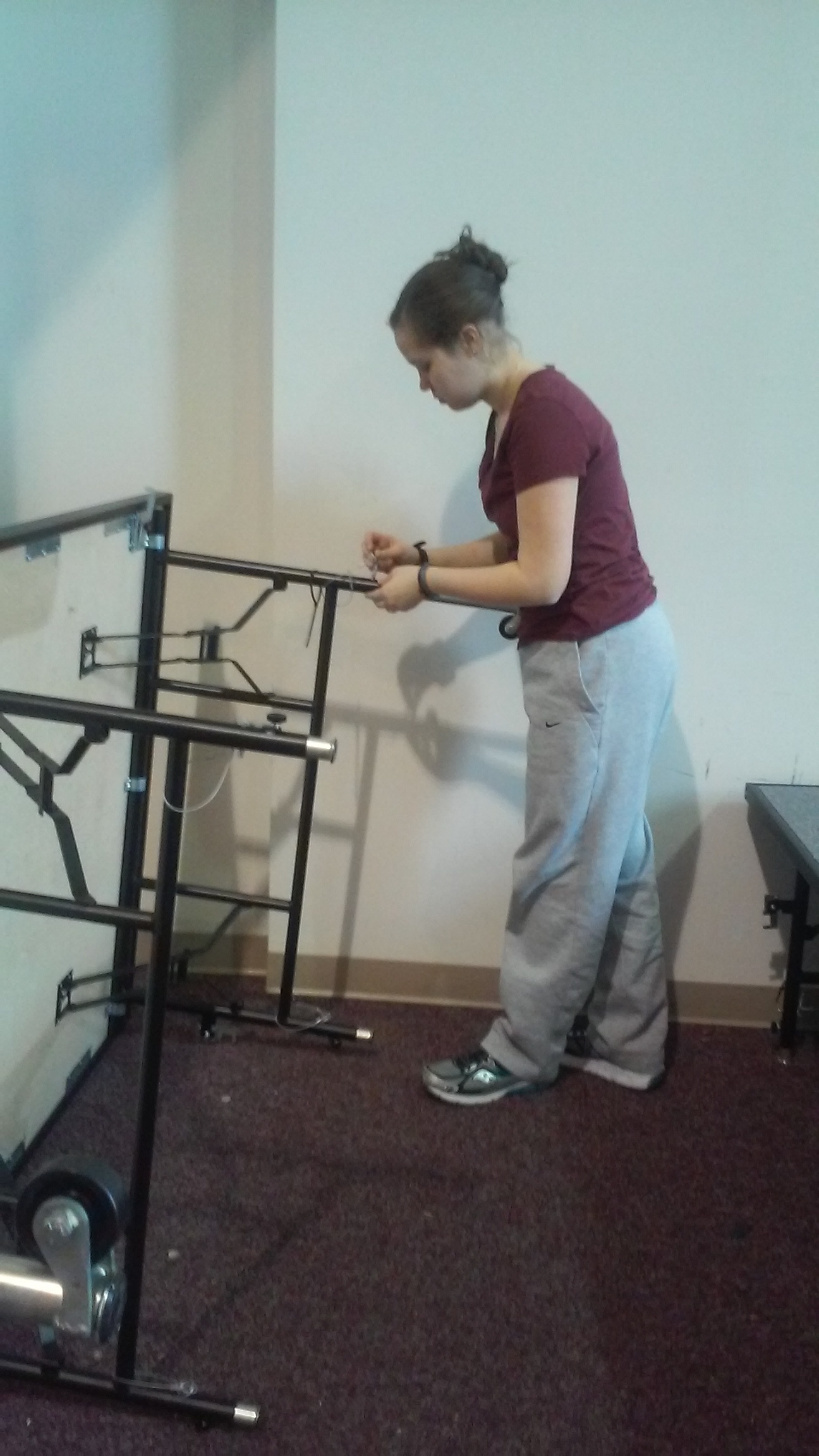 Elizabeth Neumann working on raising the stages.