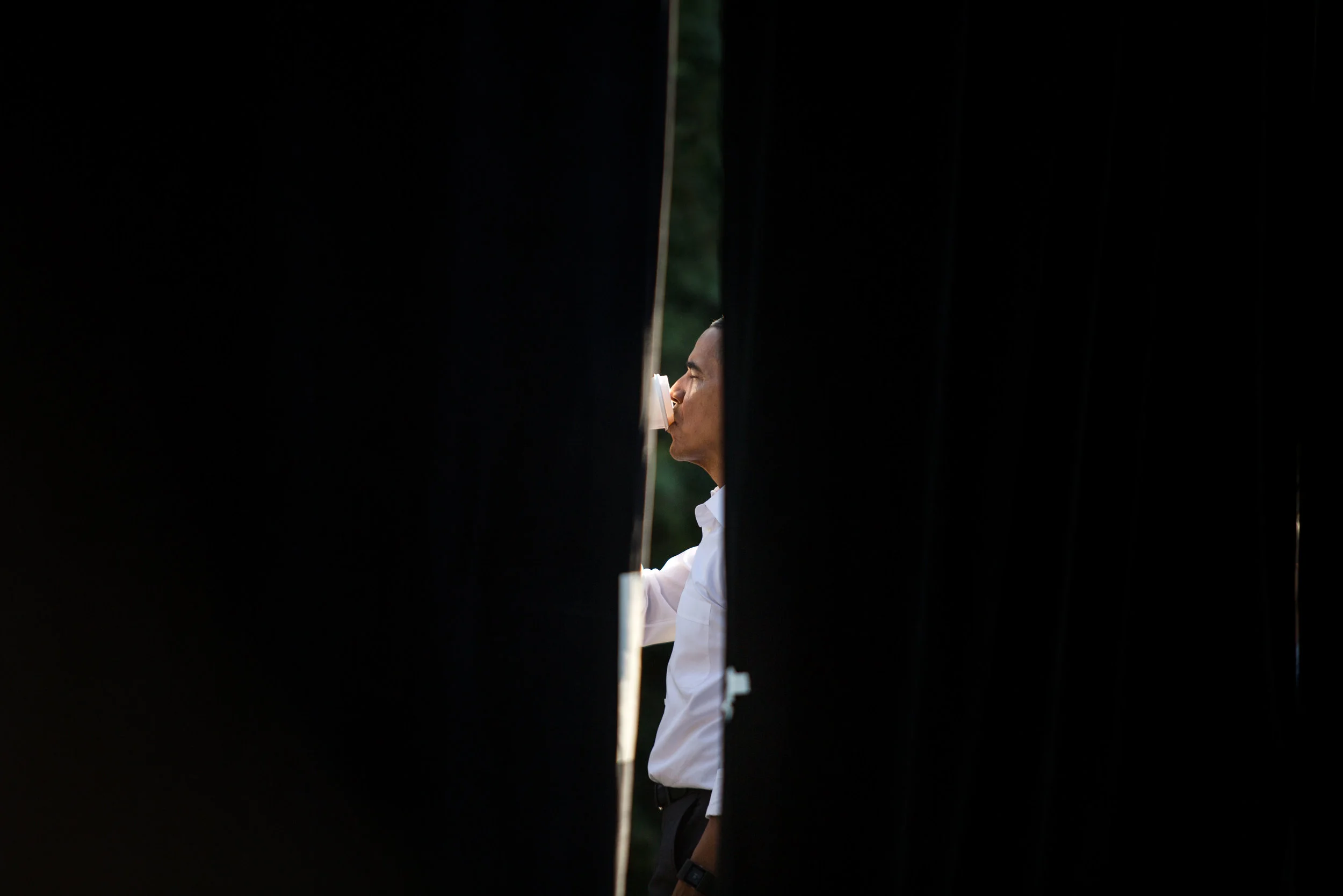 President Barack Obama finishes his coffee moments before addressing students at The University of North Carolina at Chapel Hill while on the campaign trail for Hillary Clinton.