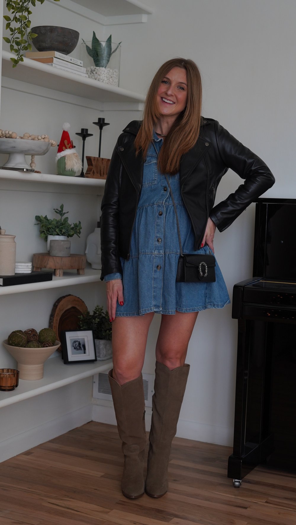  Jessica Ashley wears The Jacket Maker Flashback leather jacket in size XS with Free People denim dress, Blondo suede knee-high boots and Gucci Dionysus small cross body bag | best leather jackets for women 