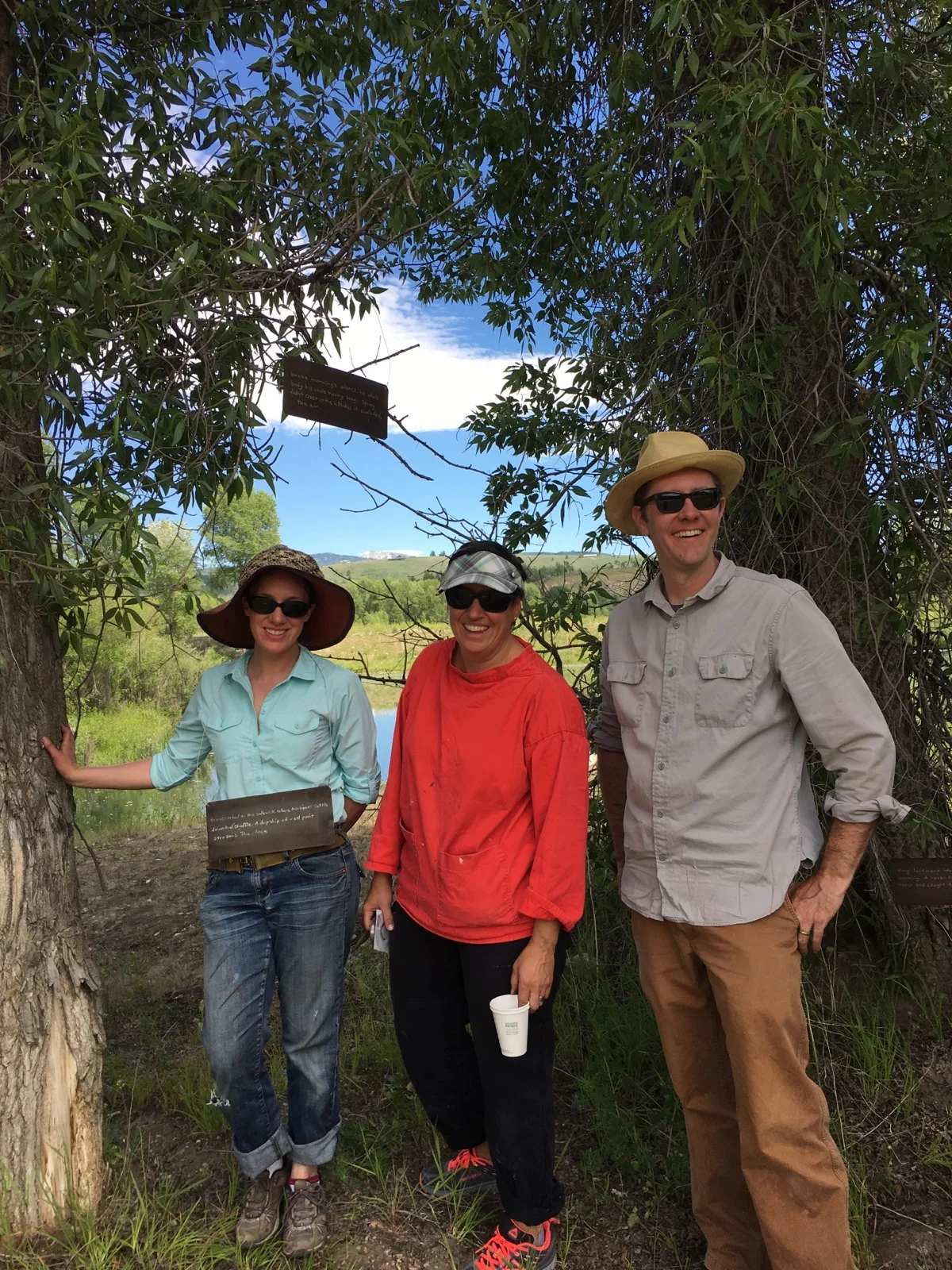 Standing in a grove with a poem that can be read in any order: Me (wearing part of the poem) Bronwyn Minton, Matt Daly