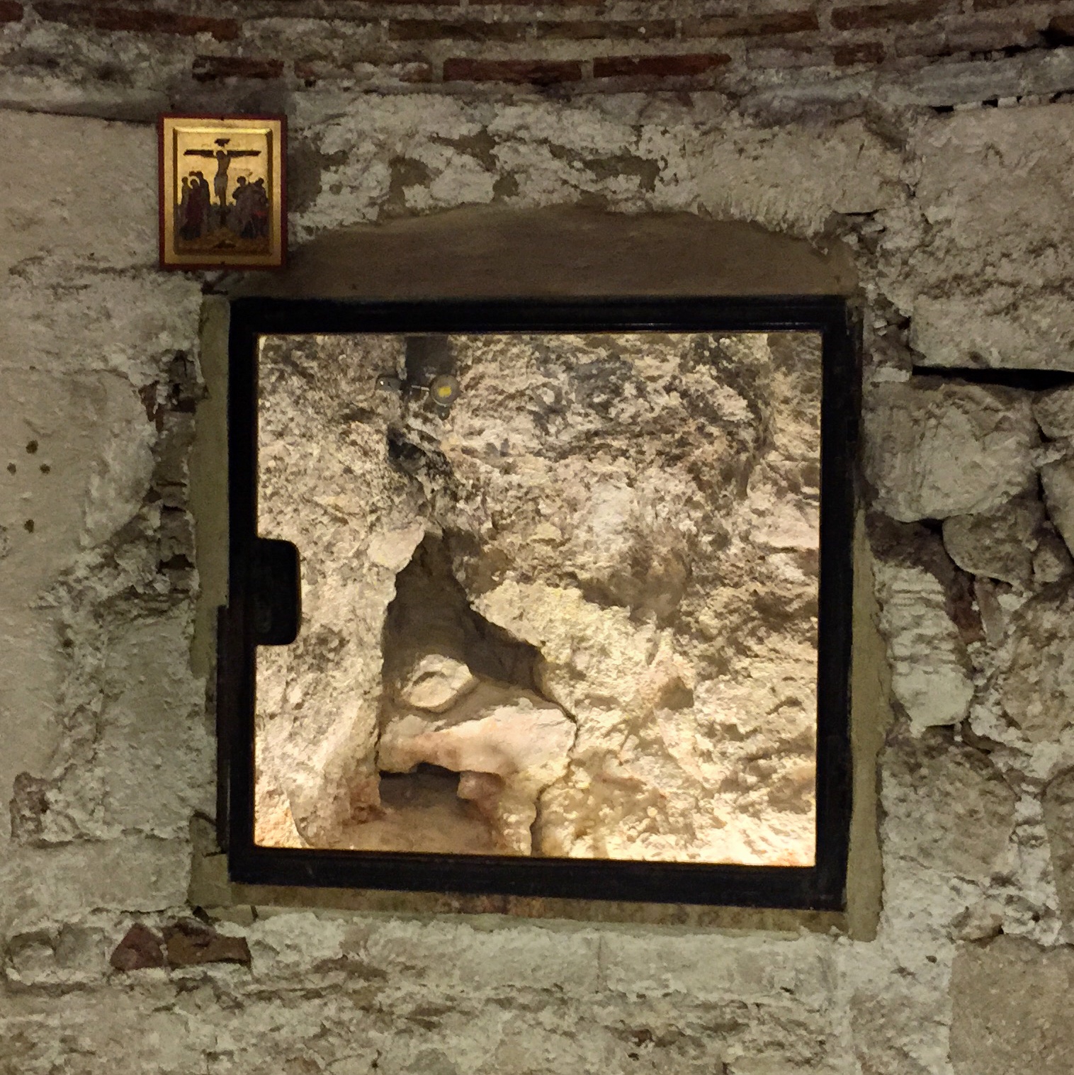 The rock of Calvary, viewed through a window in the Chapel of Adam. Allegedly cracked by an earthquake when Jesus was crucified.