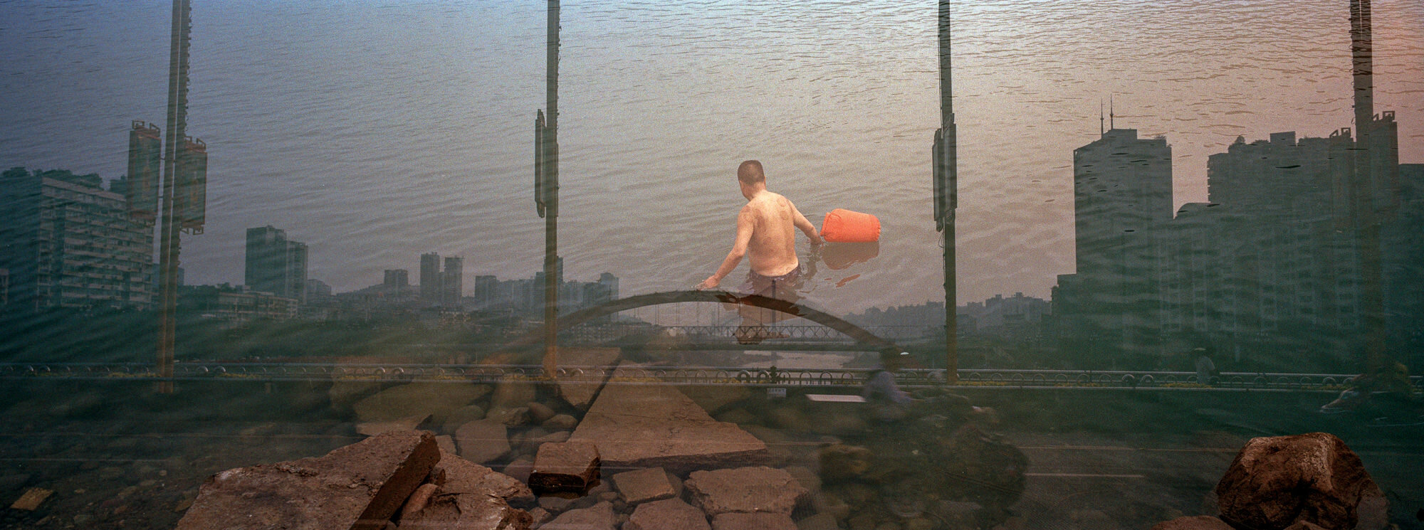  April 20, 2018, Yibin, China - Double exposure of a man about to take a swim in the Yangtze River. 