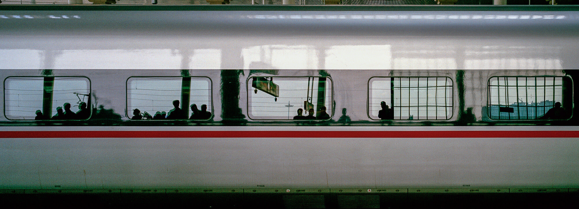  April 24, 2018, Nanjing, China - Passengers’ reflection in the windows of a high speed train on the platform at South Nanjing Railway Station. 