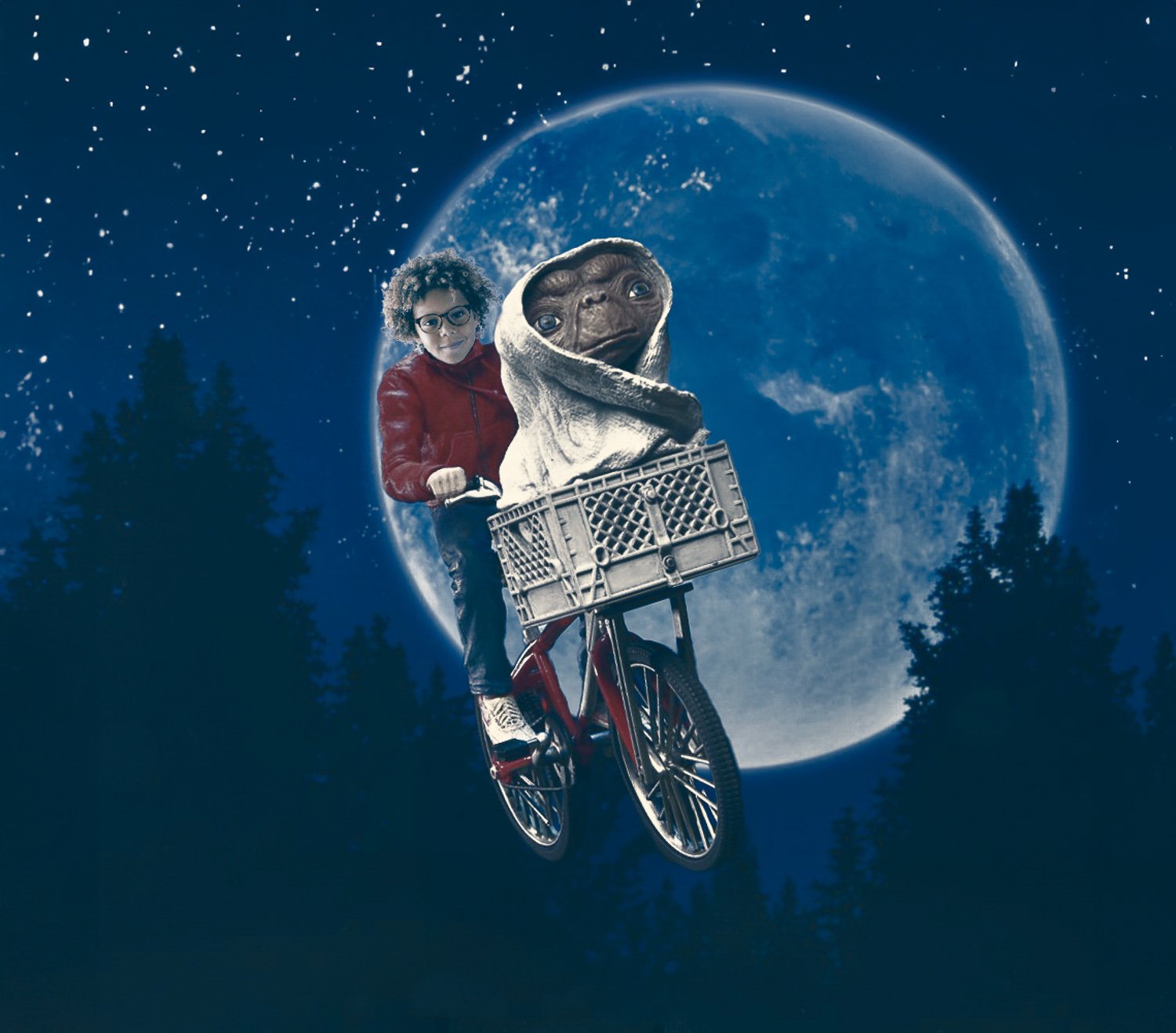 A boy on a bike in E.T. themed background