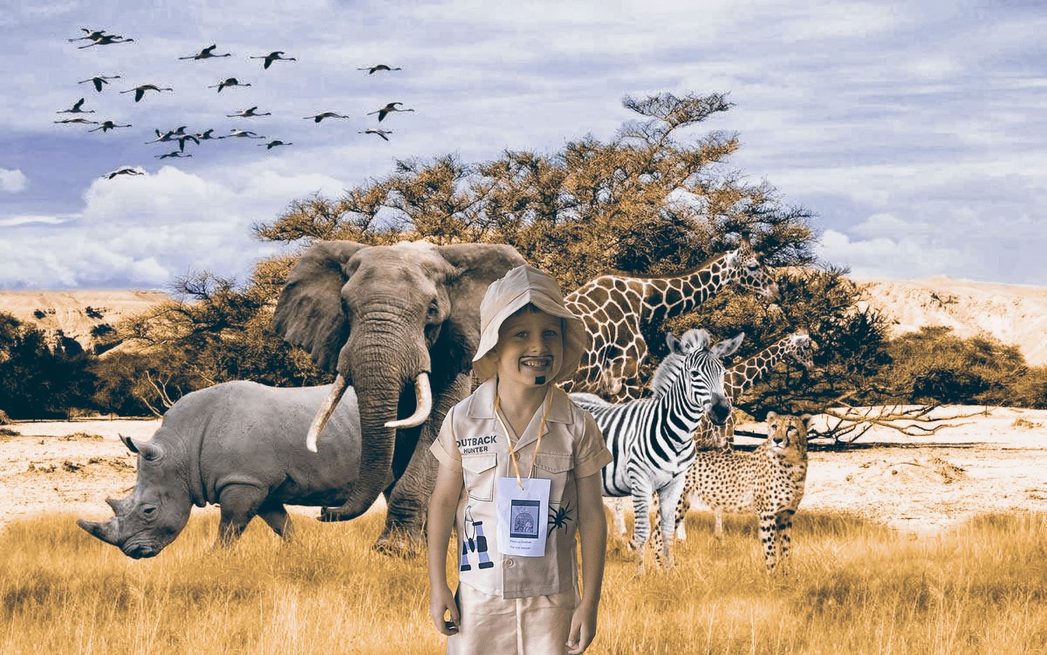 boy in a safari suit standing in wildlife park
