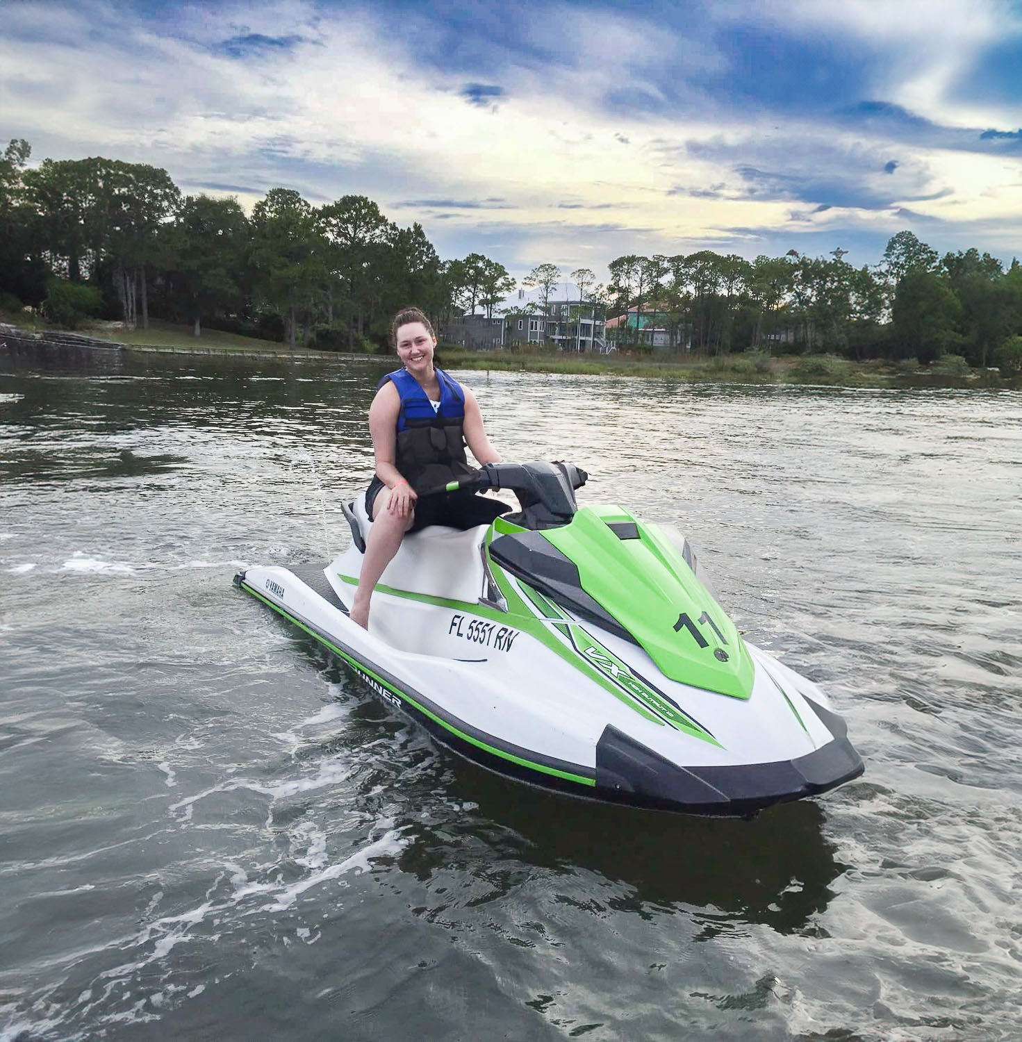 A woman sitting in a jet ski on the water