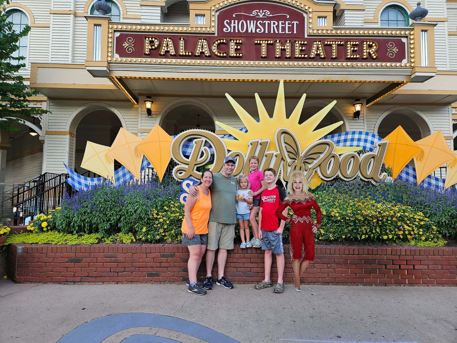 A family of six posing for the camera outside a theater 