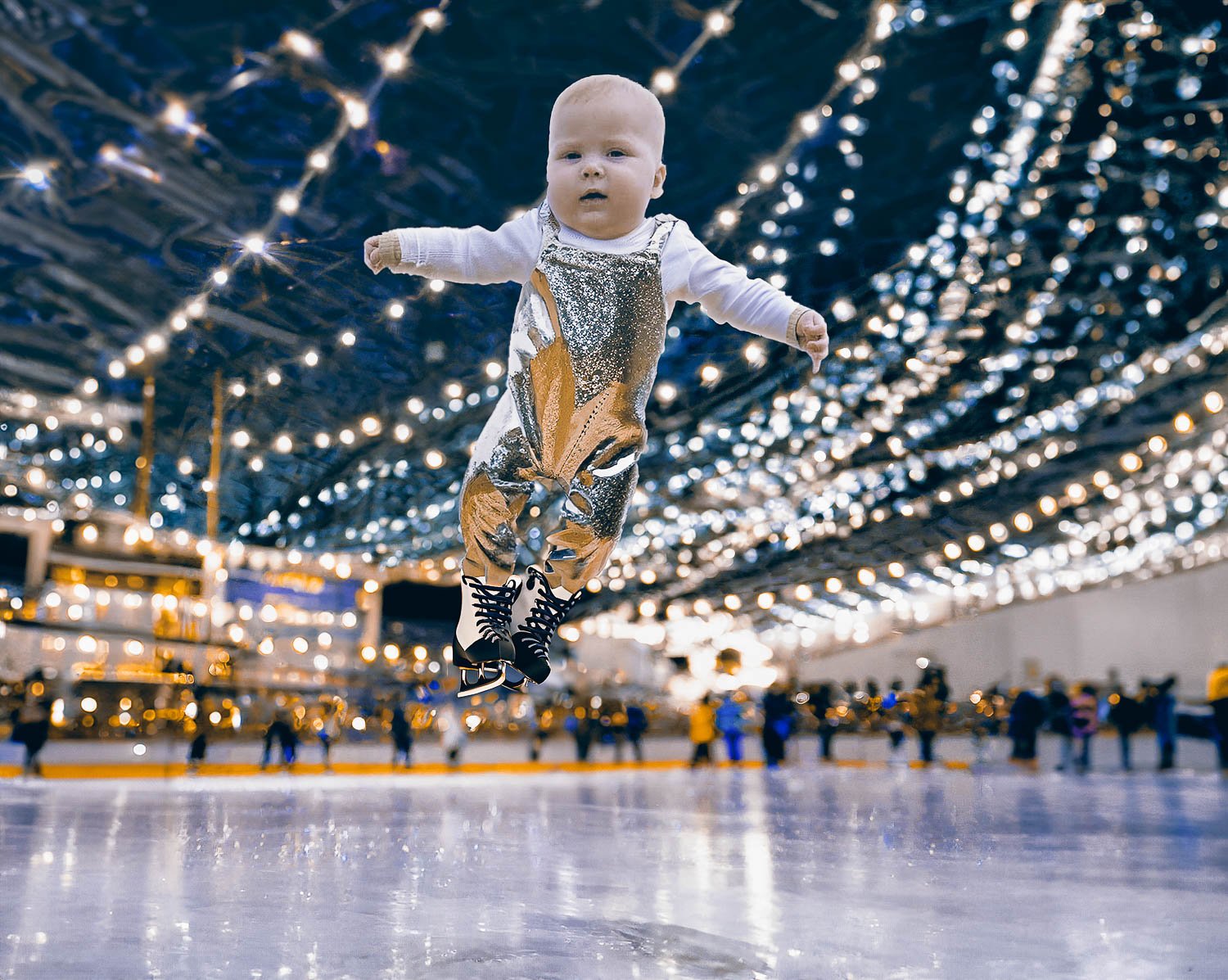 A baby boy performing ice skating jump