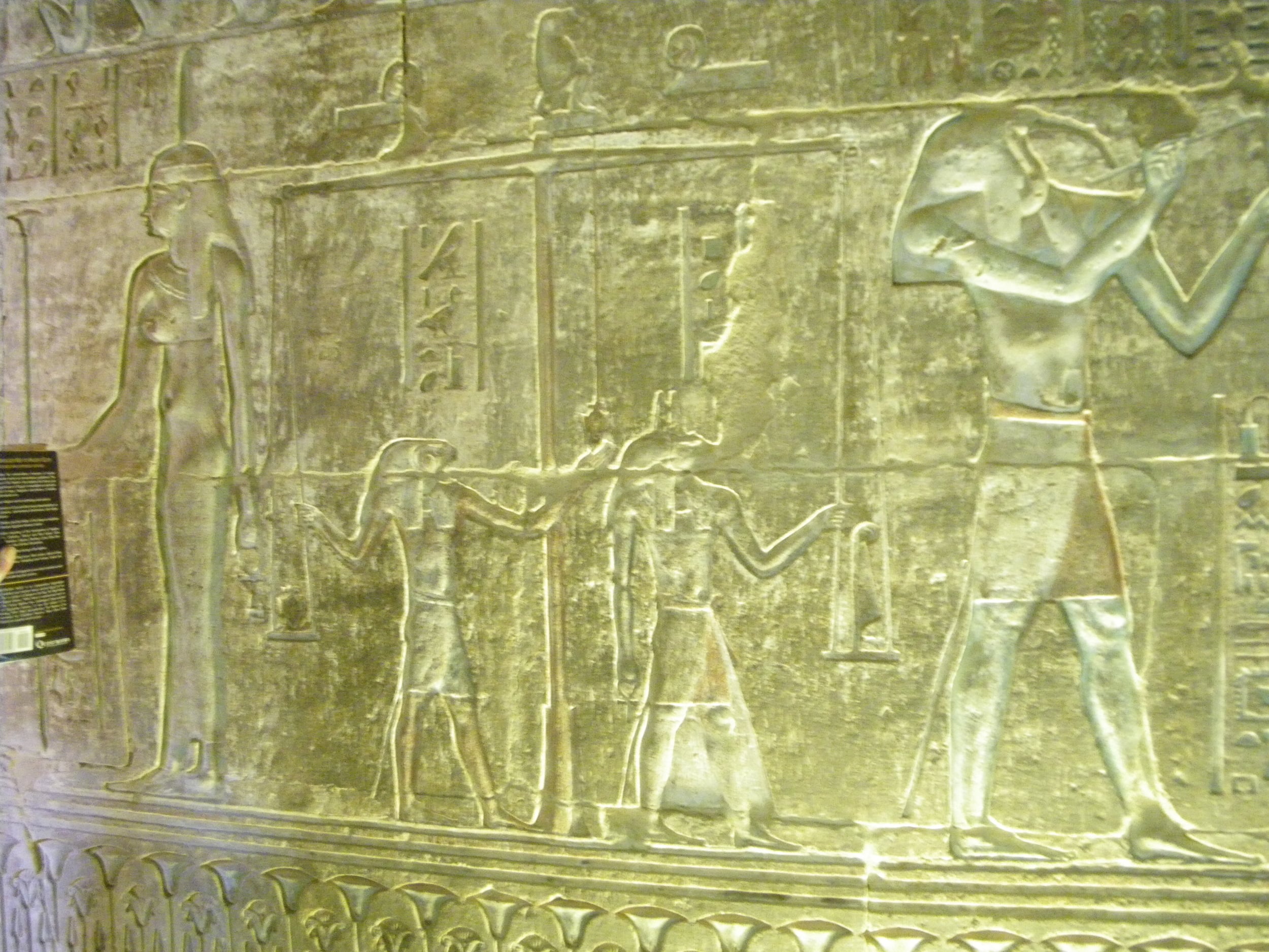 Figure 2. An image of the Weighing of the Heart theme from a Ptolemaic Tomb, Deir el Medinah, Egypt. From left to right are the neters/gods Maat, Horus, Anubis and Djehuty/Thoth. Sitting onto of the scales is a Hamadryas baboon representing Djehuty as A'an the principle of equilibrium.