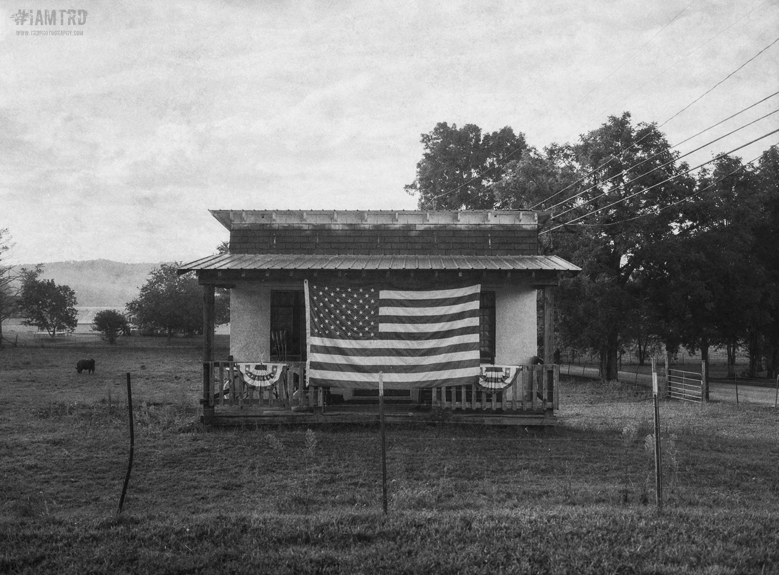 Large American Flag on Porch - Abandoned old Post Office - Georgetown, Tennessee area
Kodak Tri X Film Photography 
Photographer Ricky Davis of TRD Photography