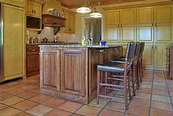 End view of large kitchen island. The island contained a second oven and dishwasher as well, as all other available space was configured for storage.