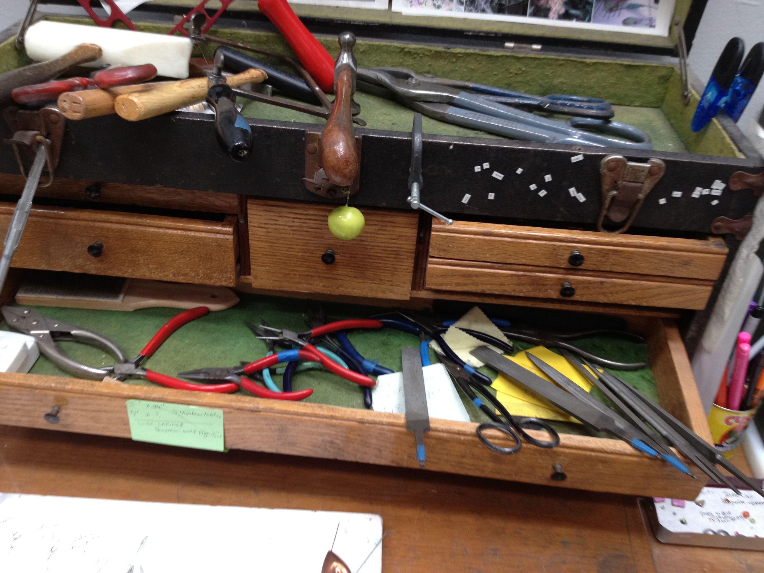 This antique tool chest sits on my work desk, spilling with tools I use daily.