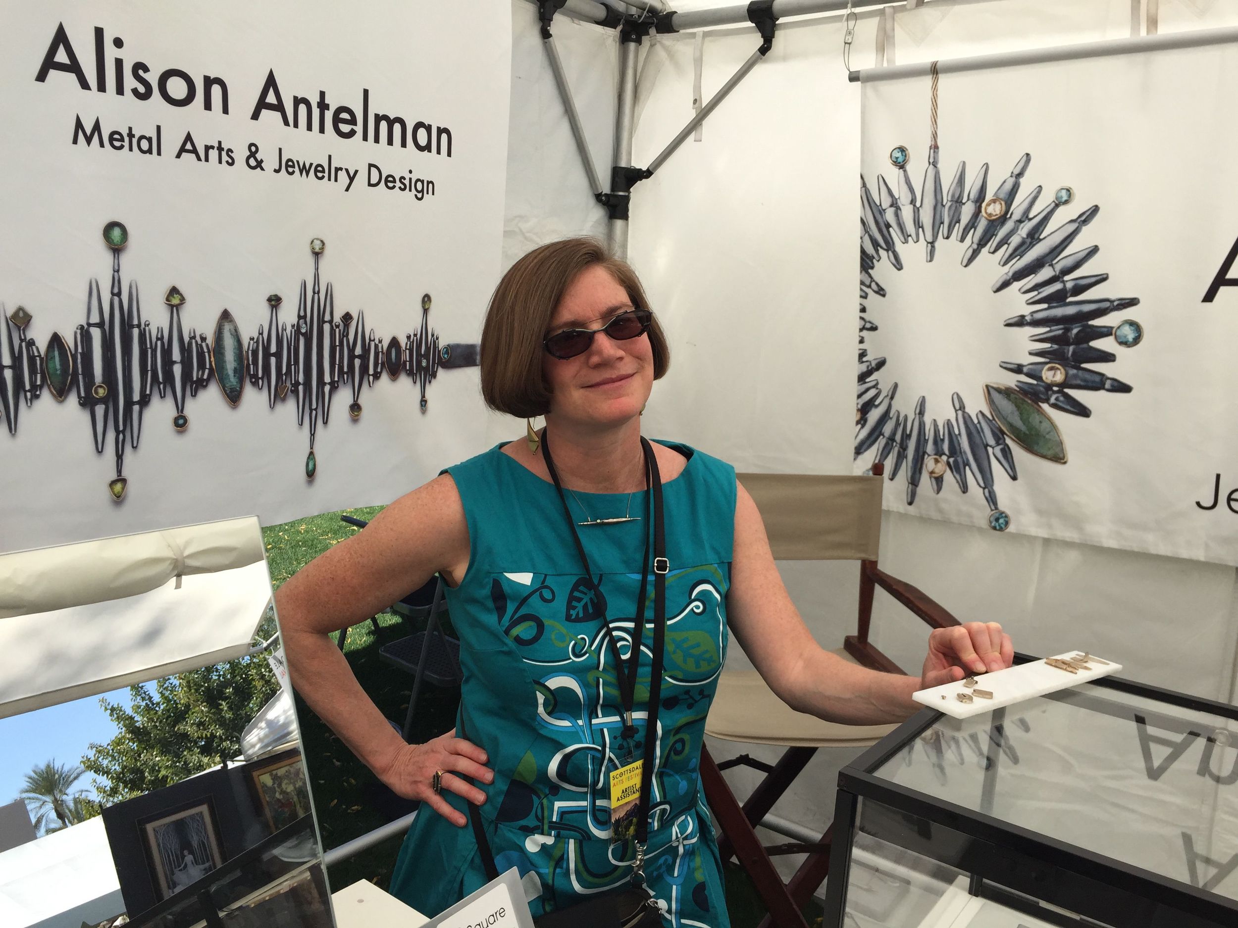 In my booth at the Scottsdale Arts Festival..with jewelry banners larger than life.